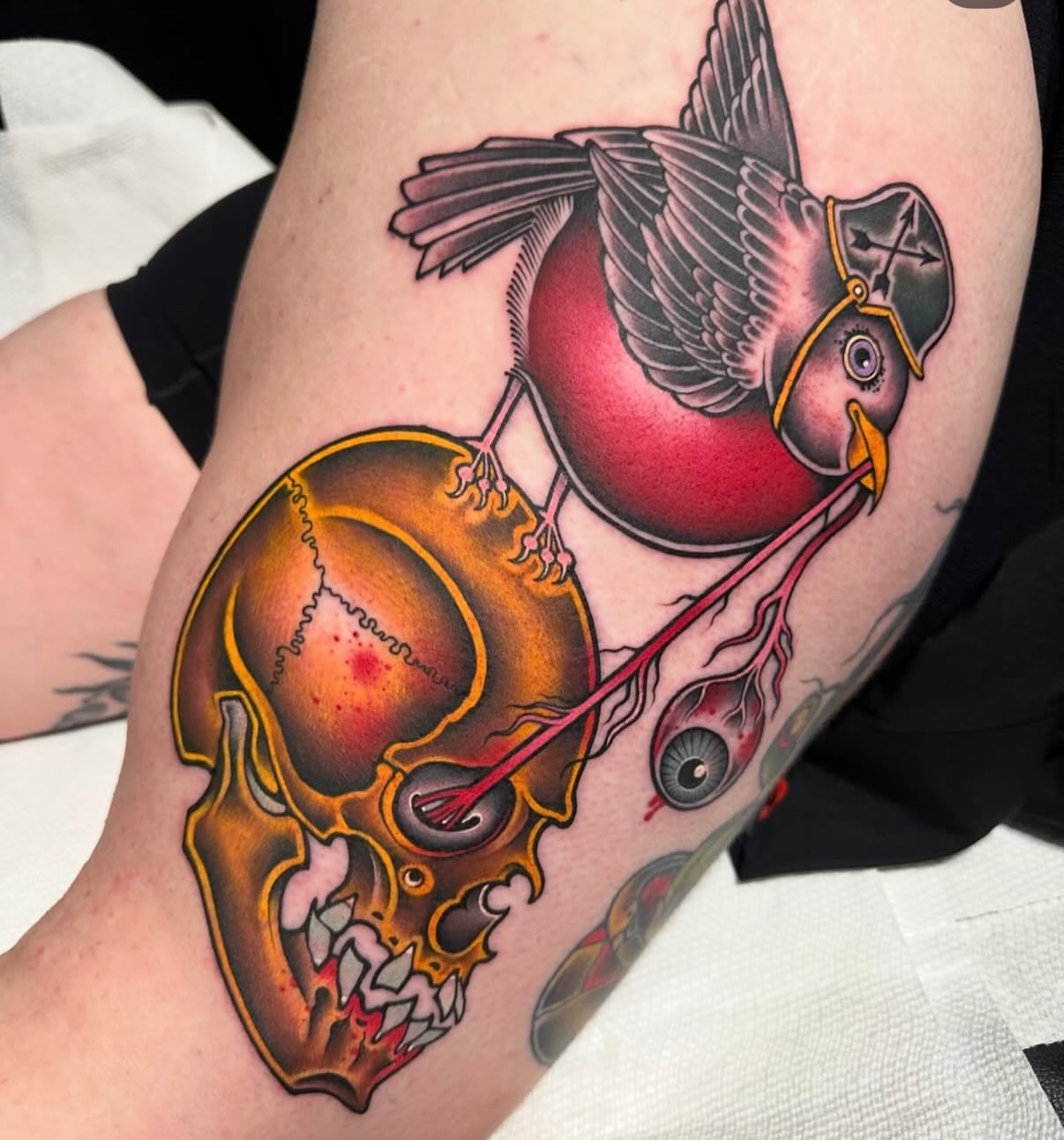 Bird and skull American traditional tattoo on the thigh by Mark Boller