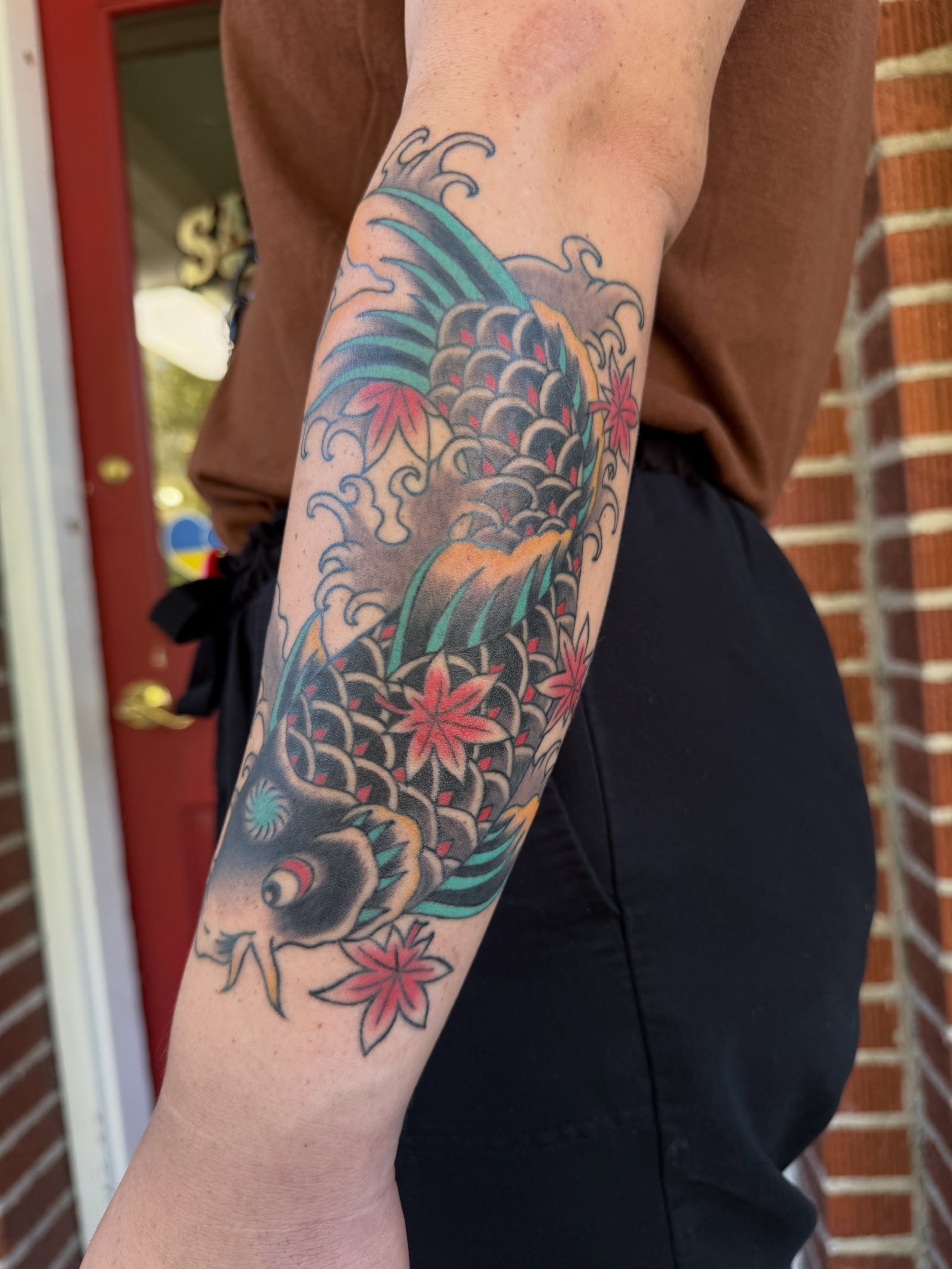 Koi fish American traditional tattoo on the forearm by Kaysen