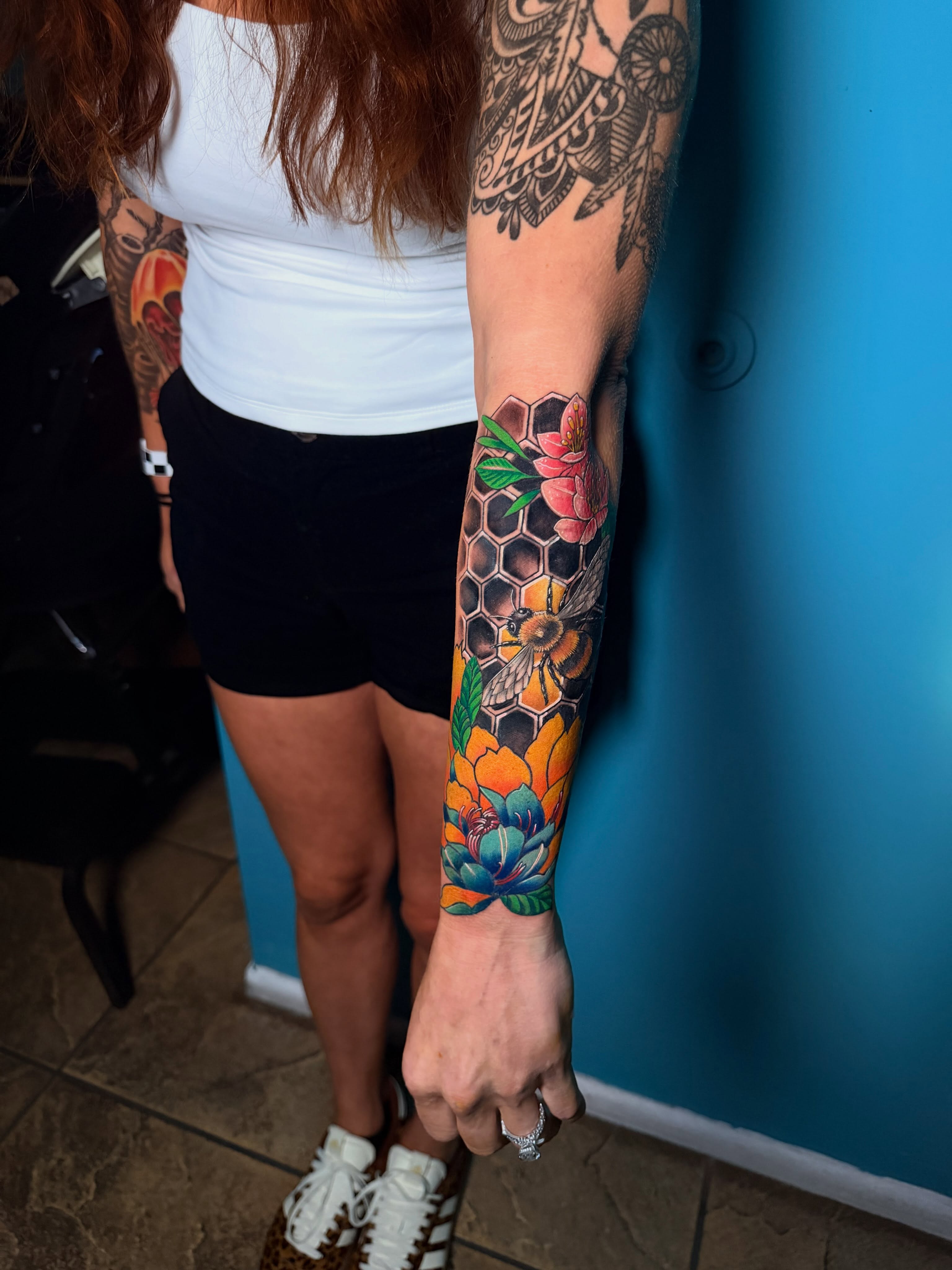 Bees and flowers realism tattoo on the forearm by Tattoos in Fort Myers, Fl