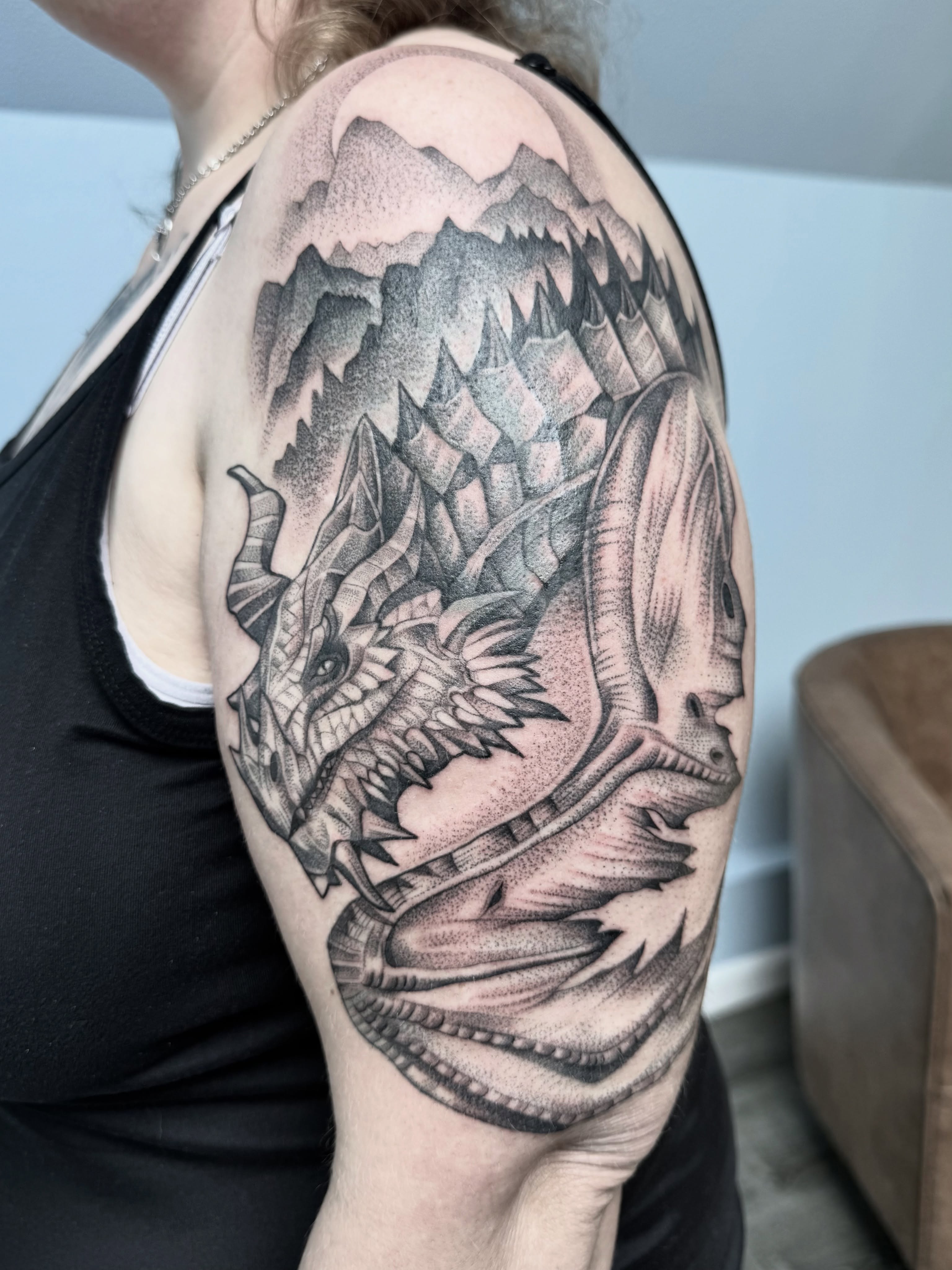 Dragon dotwork tattoo on the shoulder by Miles Romero Smith