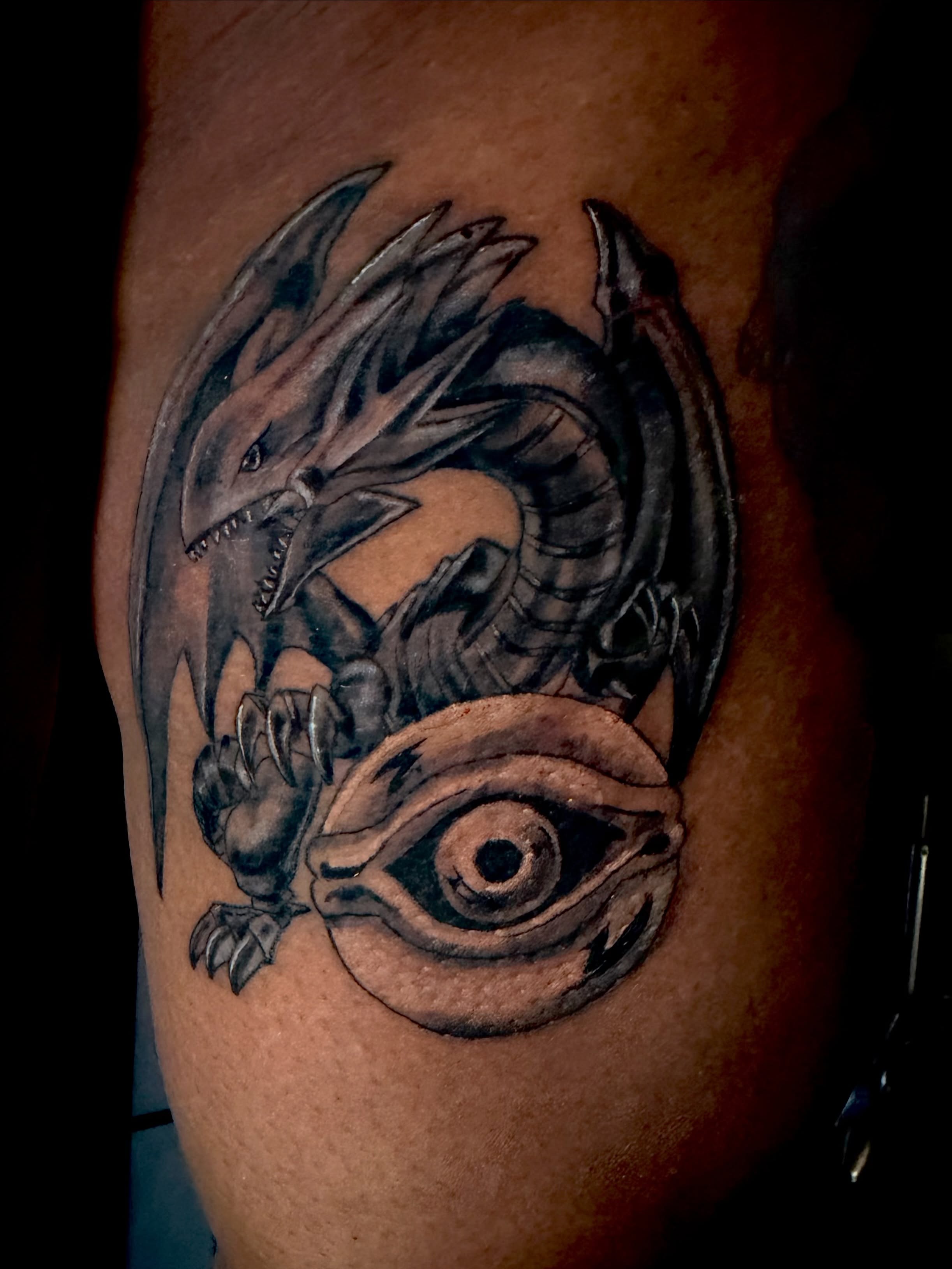 Dragon and eye realism tattoo on the forearm by Alexander Haber
