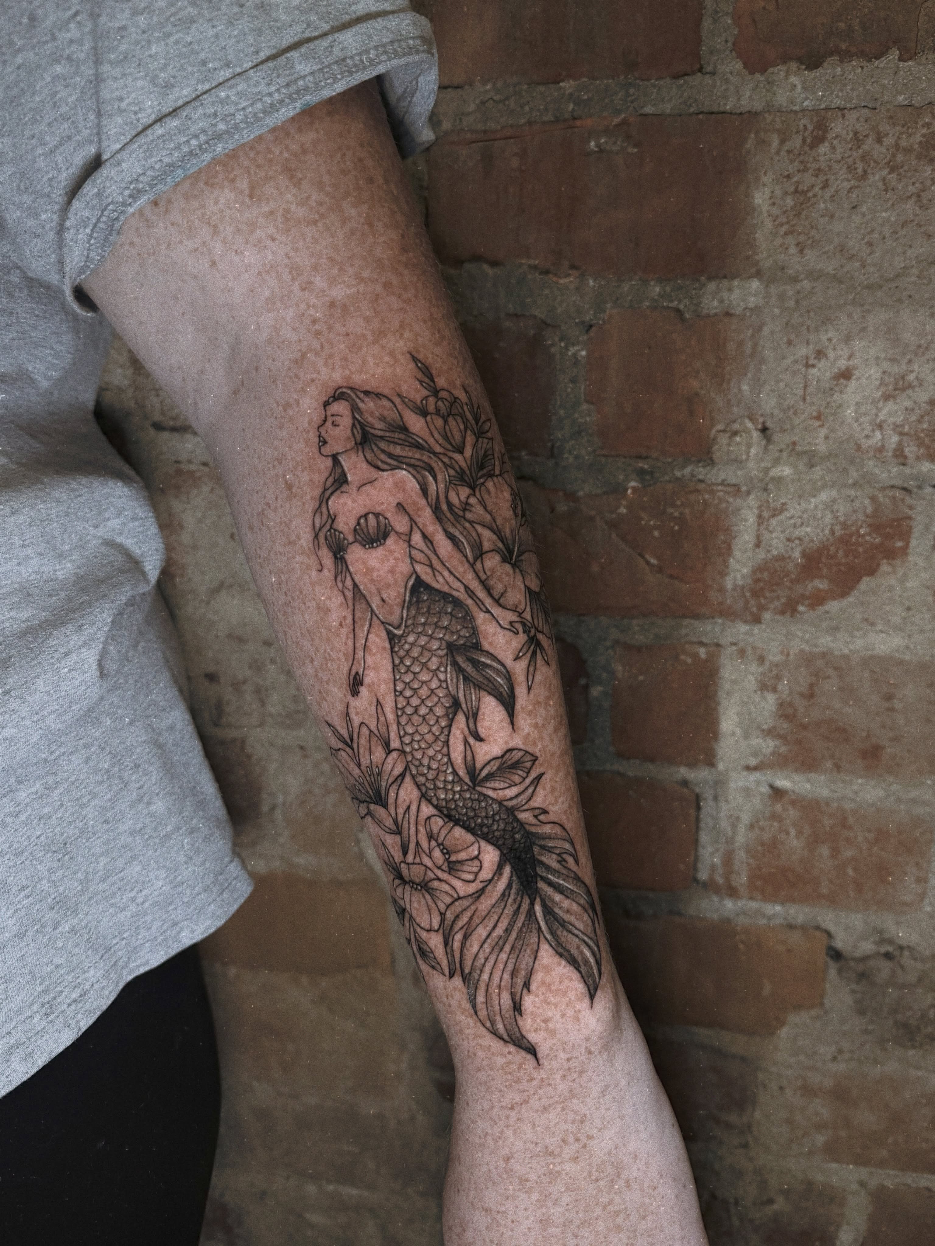 Mermaid black and grey tattoo on the forearm by E L I Z A H B e T H H D e S I G N S