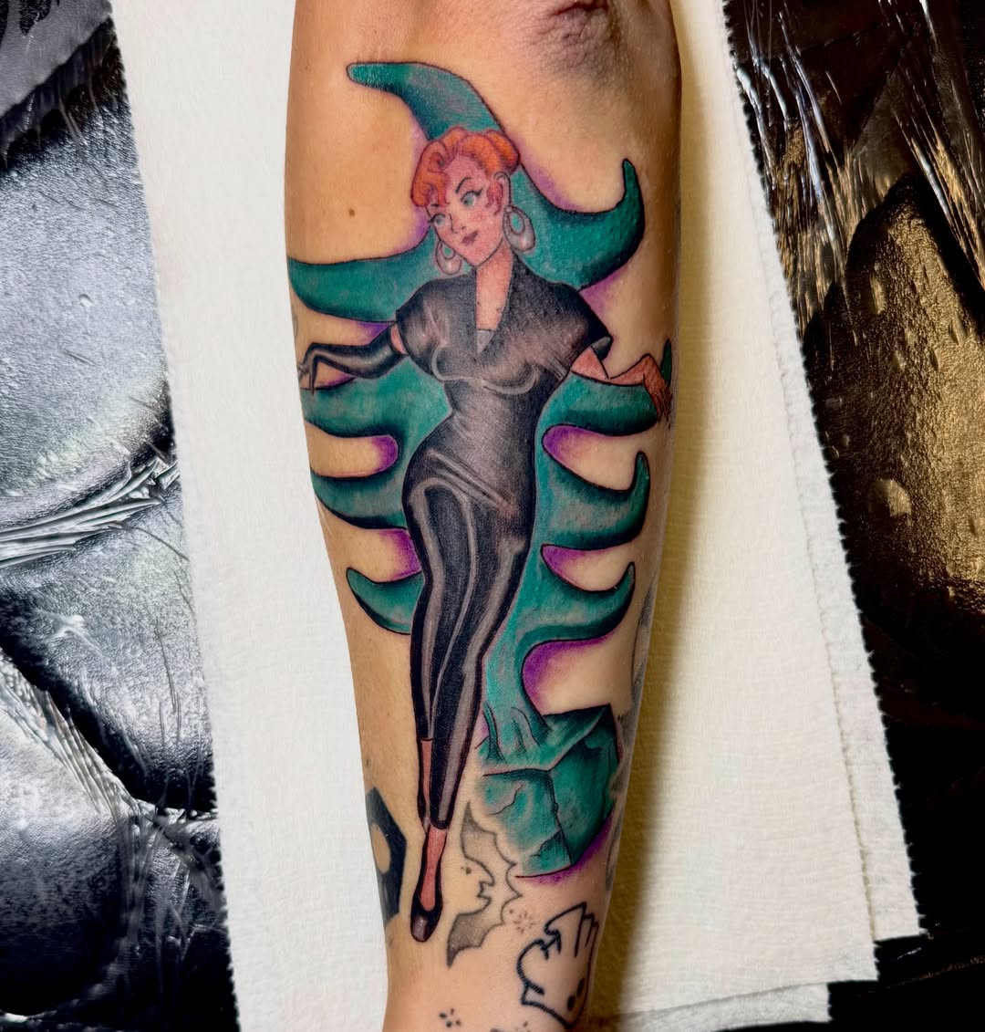 Villainess new school tattoo on the forearm by Jerry Thomas