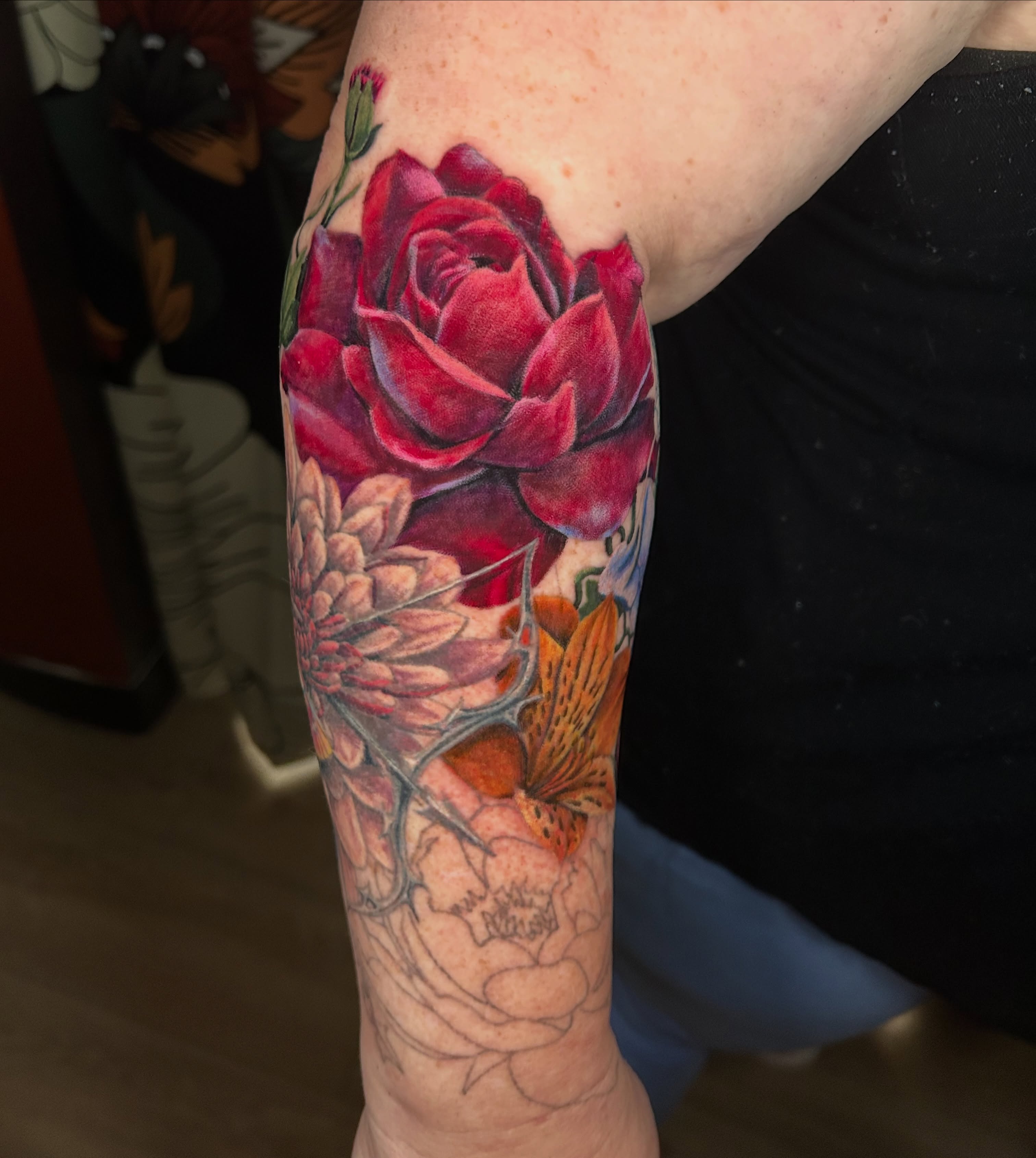 Floral arrangement realism tattoo on the forearm by Paisley Diaz, Lombard, Illinois