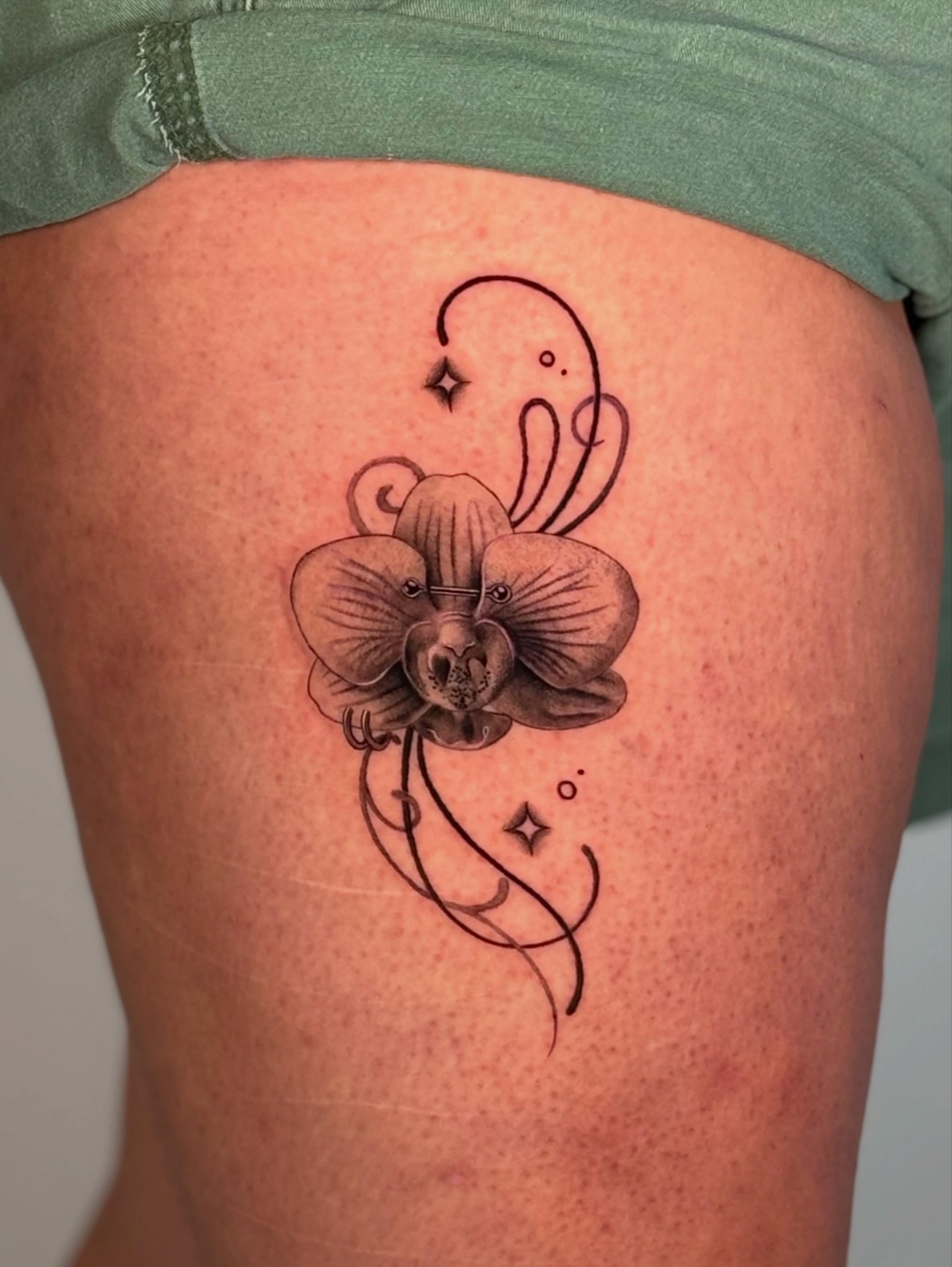 Orchid black and grey tattoo on the thigh by jaz🌀