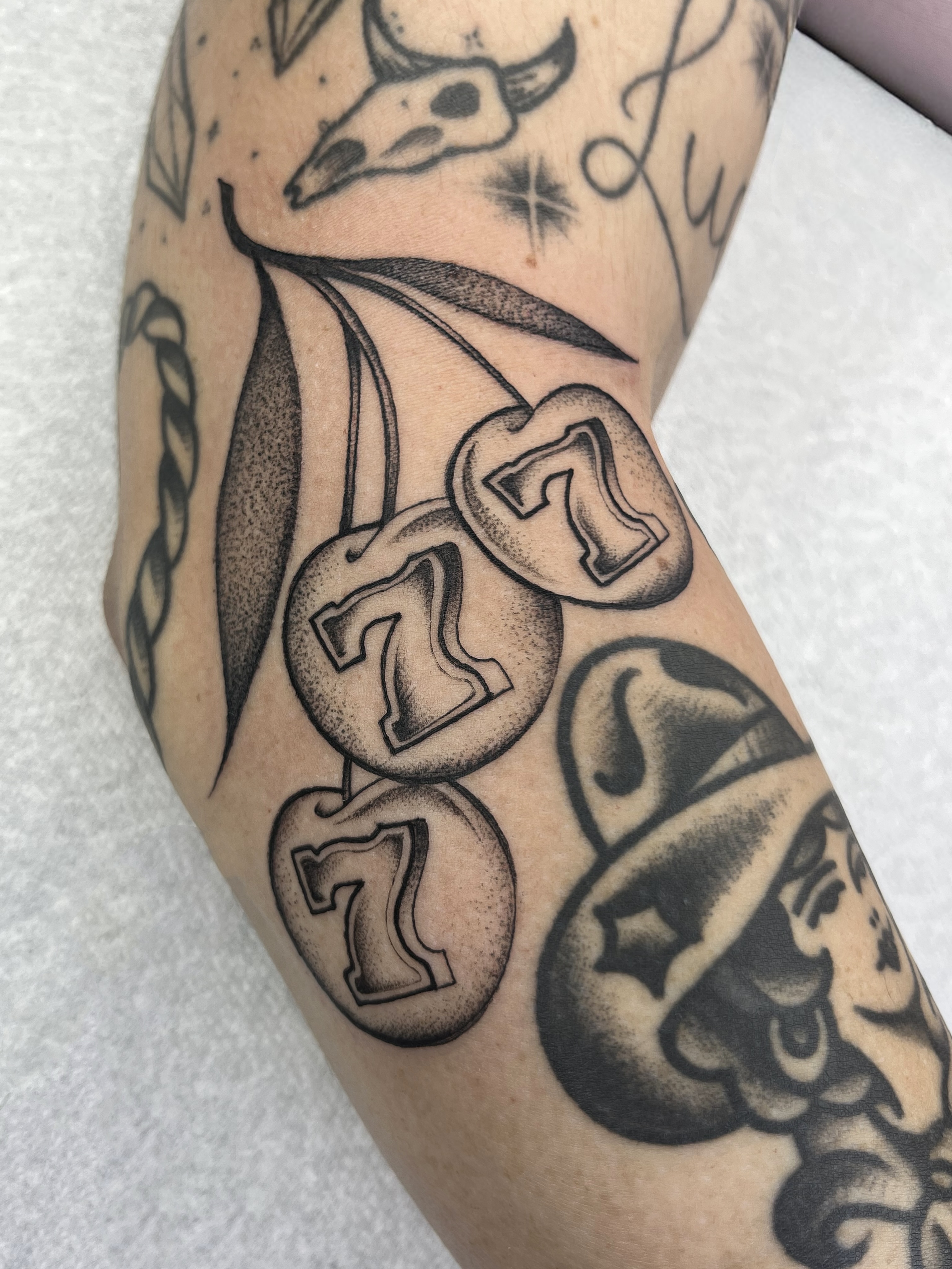 Cherries dotwork tattoo on the forearm by Sara Atamian, San Diego, California