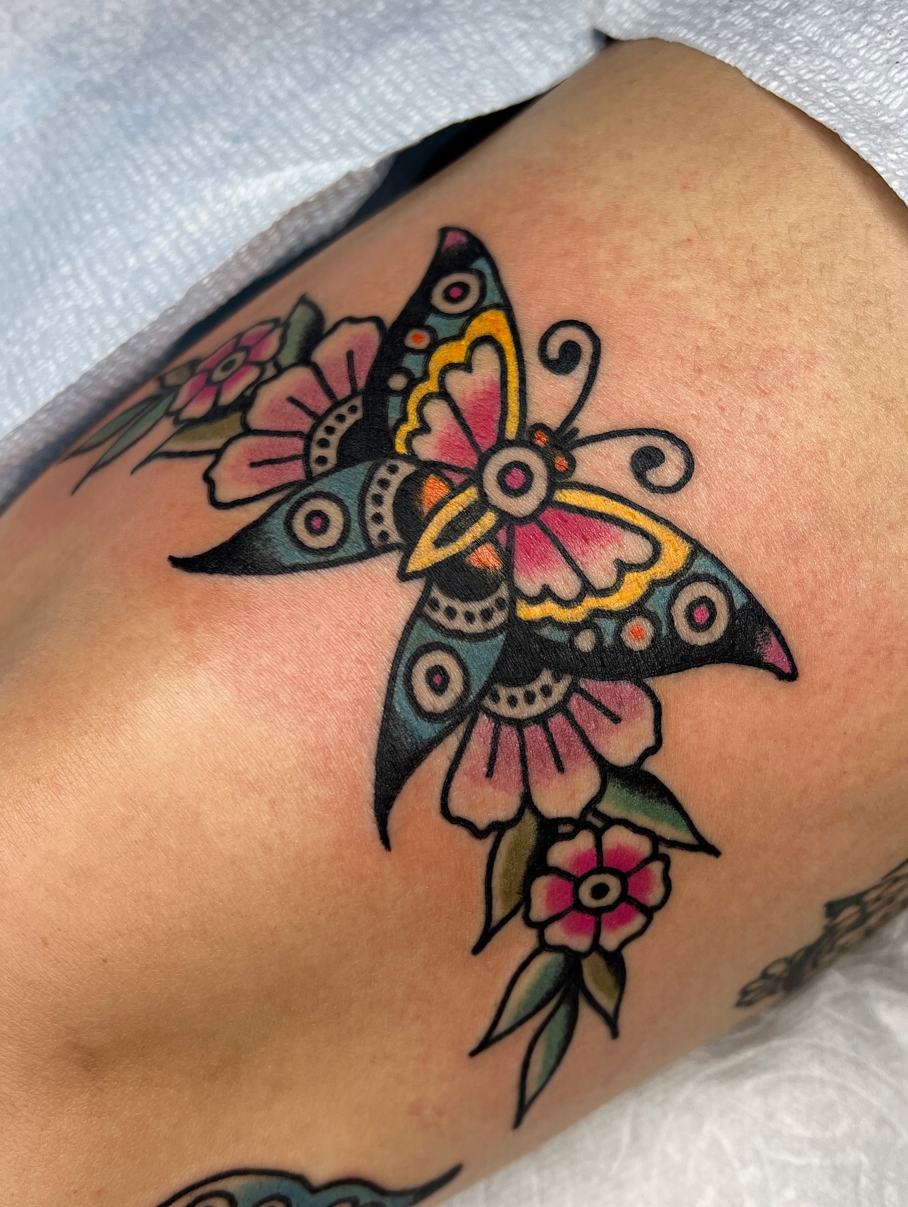 Butterfly and flowers American traditional tattoo on the thigh by Leo 🌞 Pdx Tattoo