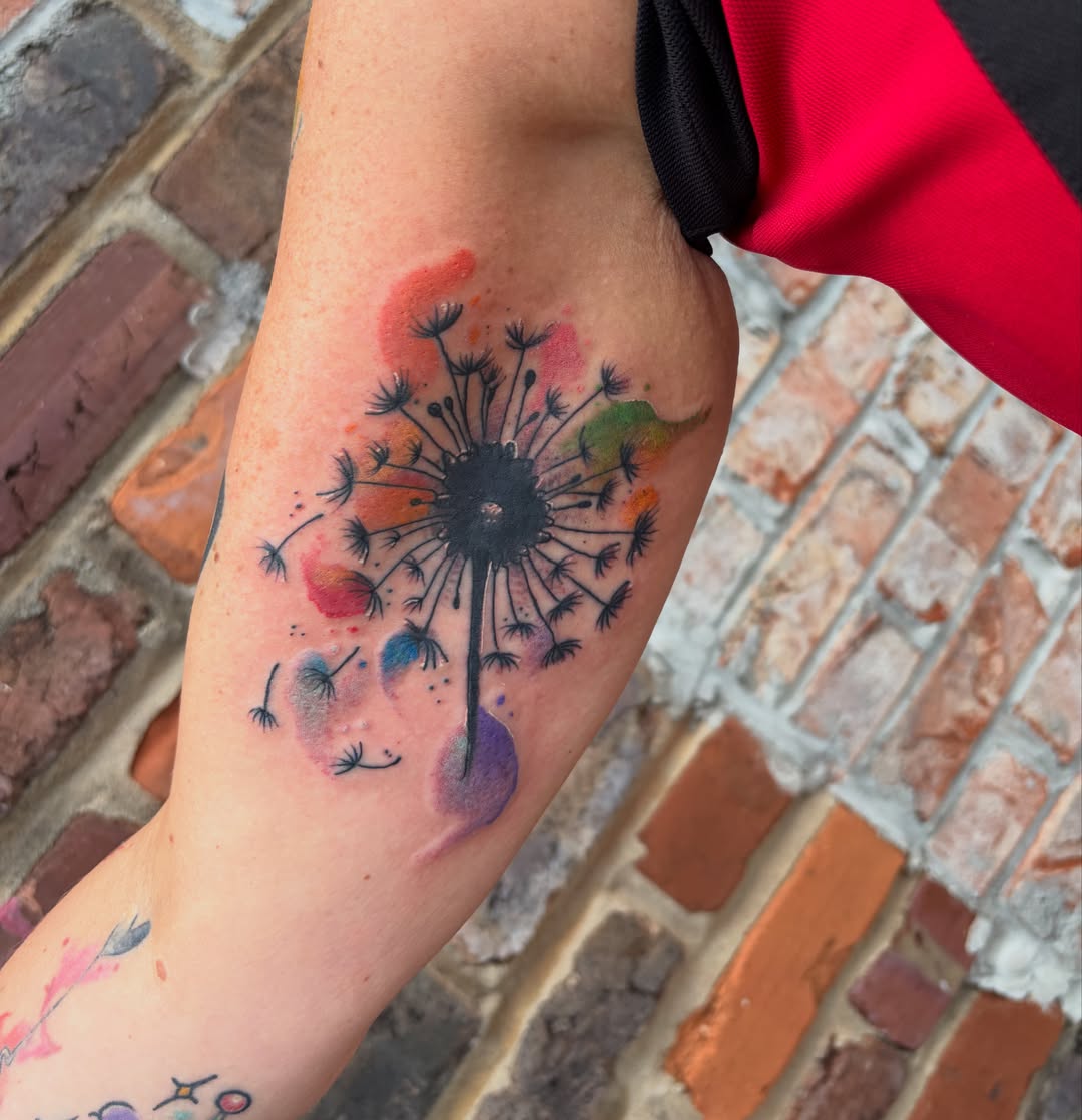 Dandelion watercolor tattoo on the forearm by Vudu Tattooer