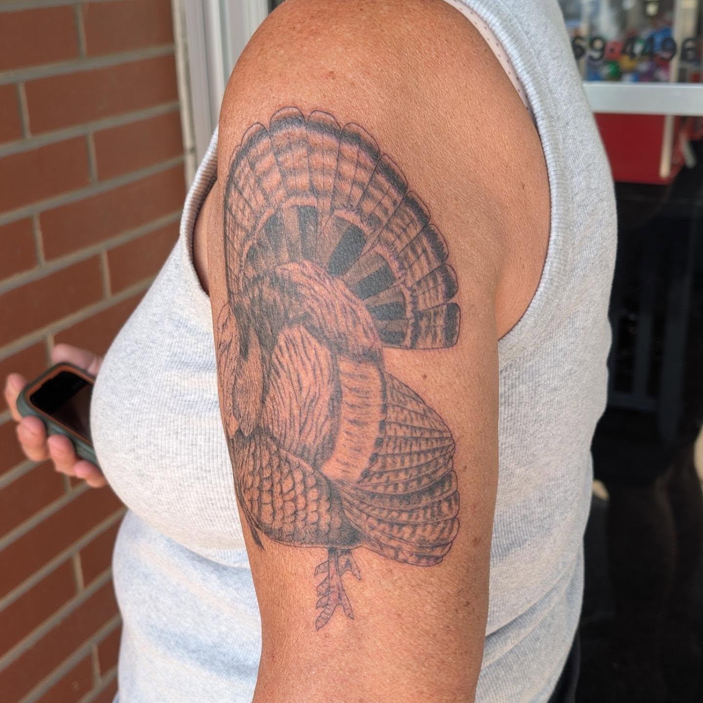 Turkey black and grey tattoo on the upper arm by Hannah Hayes, Livonia, Michigan