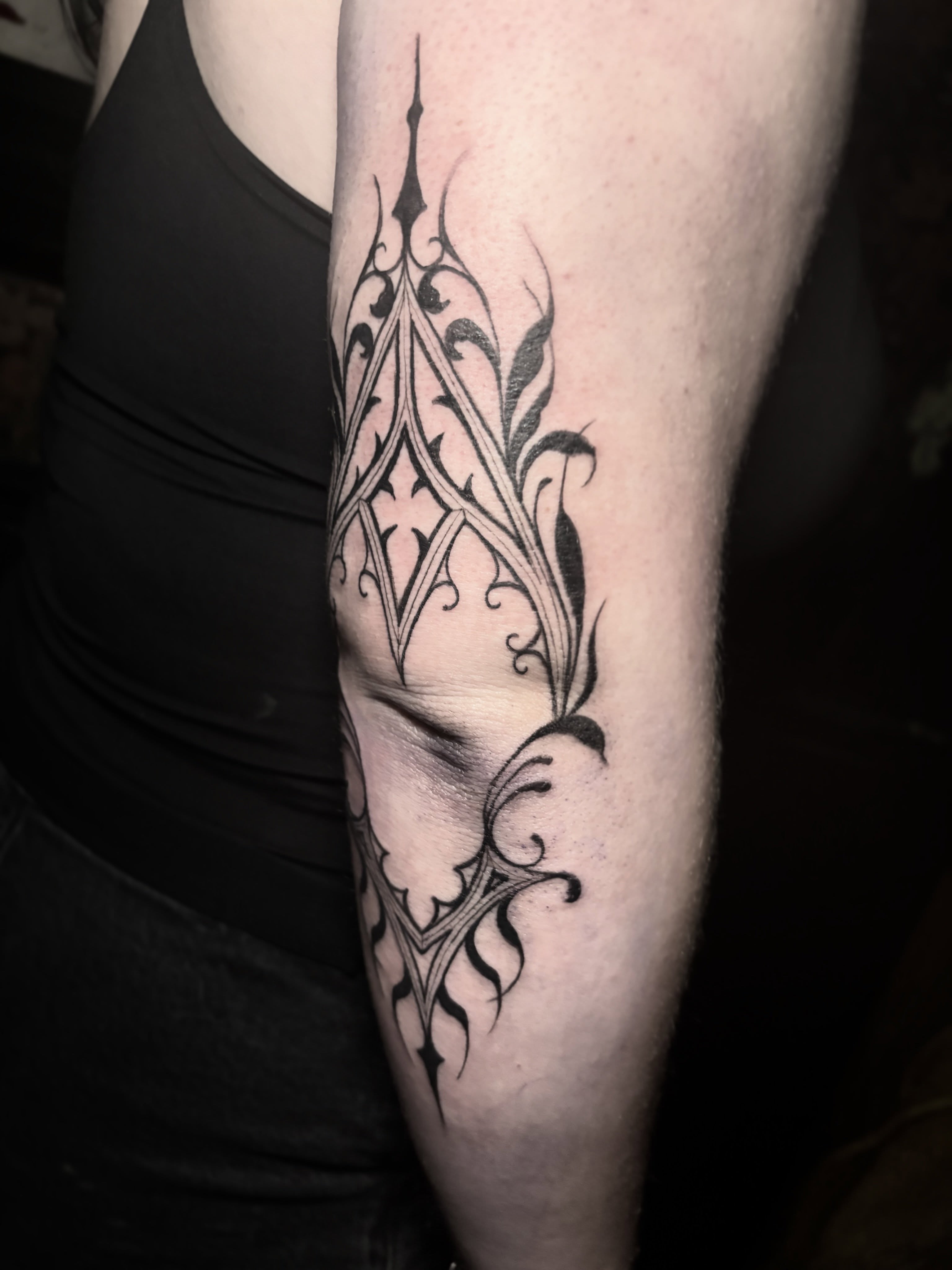 Gothic arch black and grey tattoo on the forearm by Cassandra Colleen