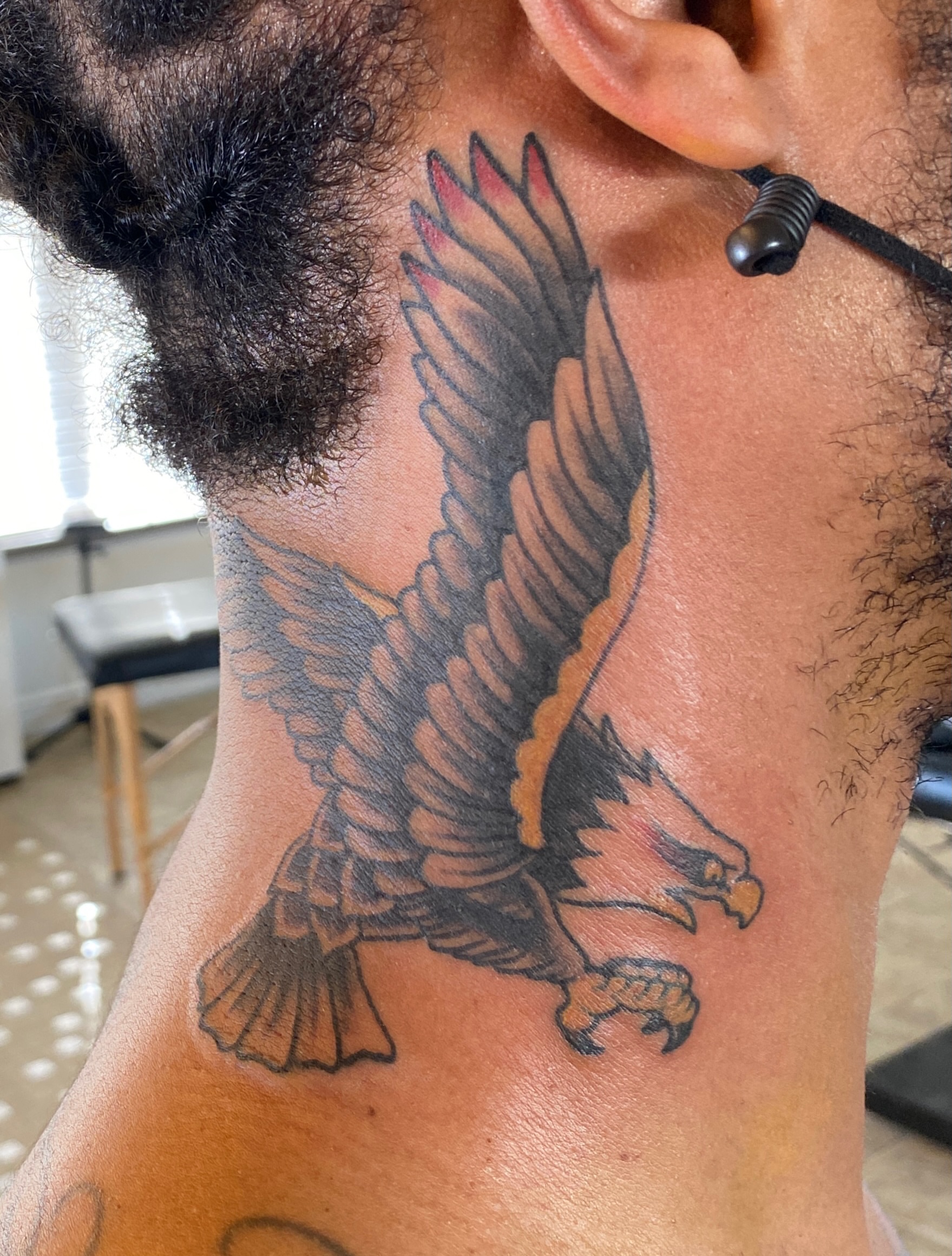 Eagle American traditional tattoo on the neck by Cary Aldridge