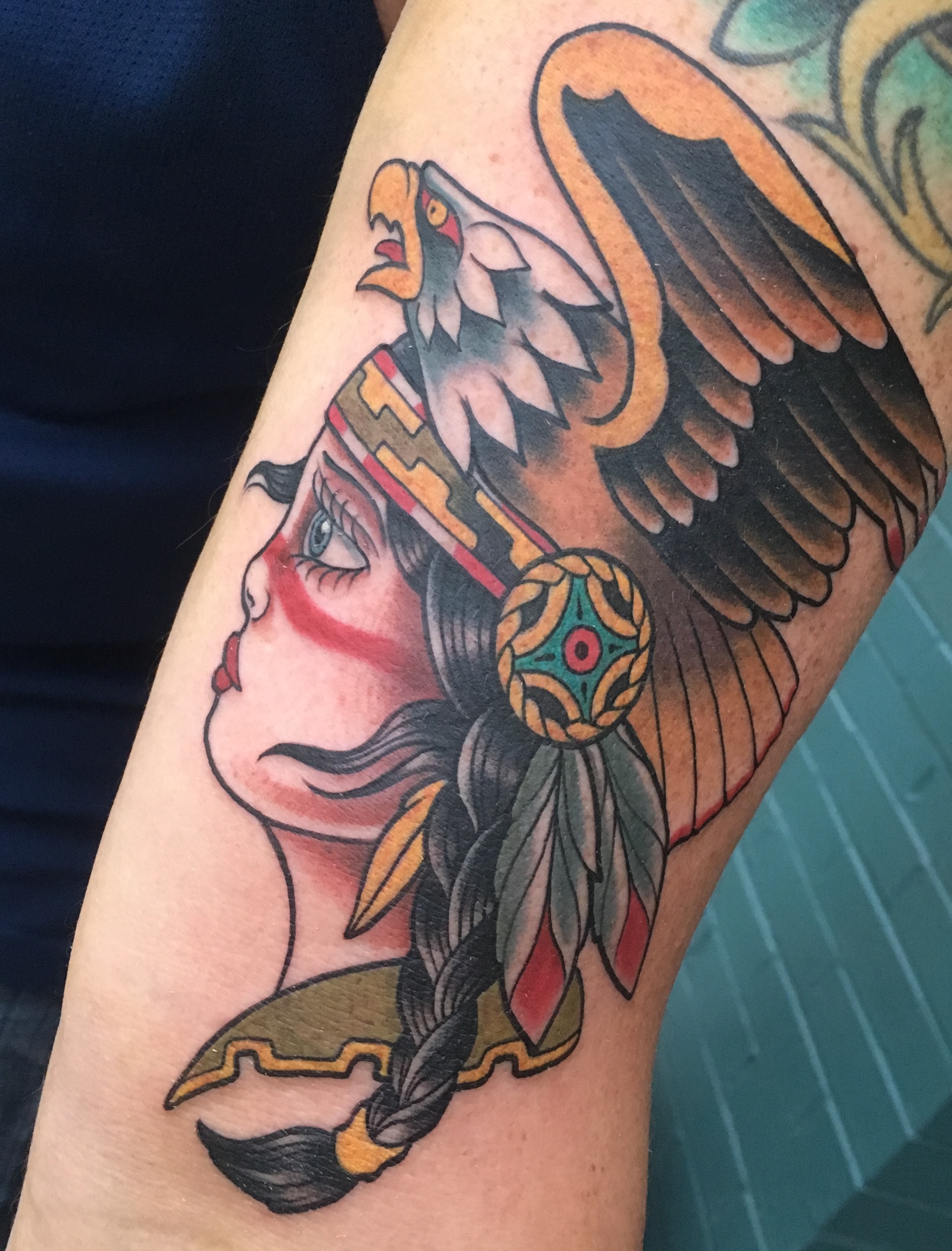 Woman with eagle headdress American traditional tattoo on the forearm by Cary Aldridge