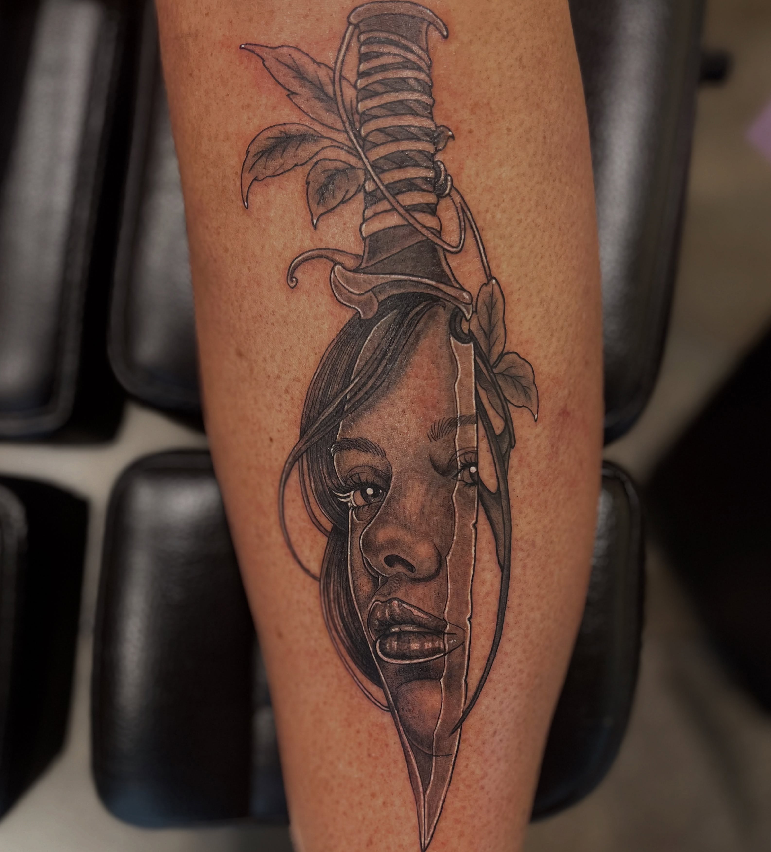Knife and woman's face realism tattoo on the forearm by Elle Miller