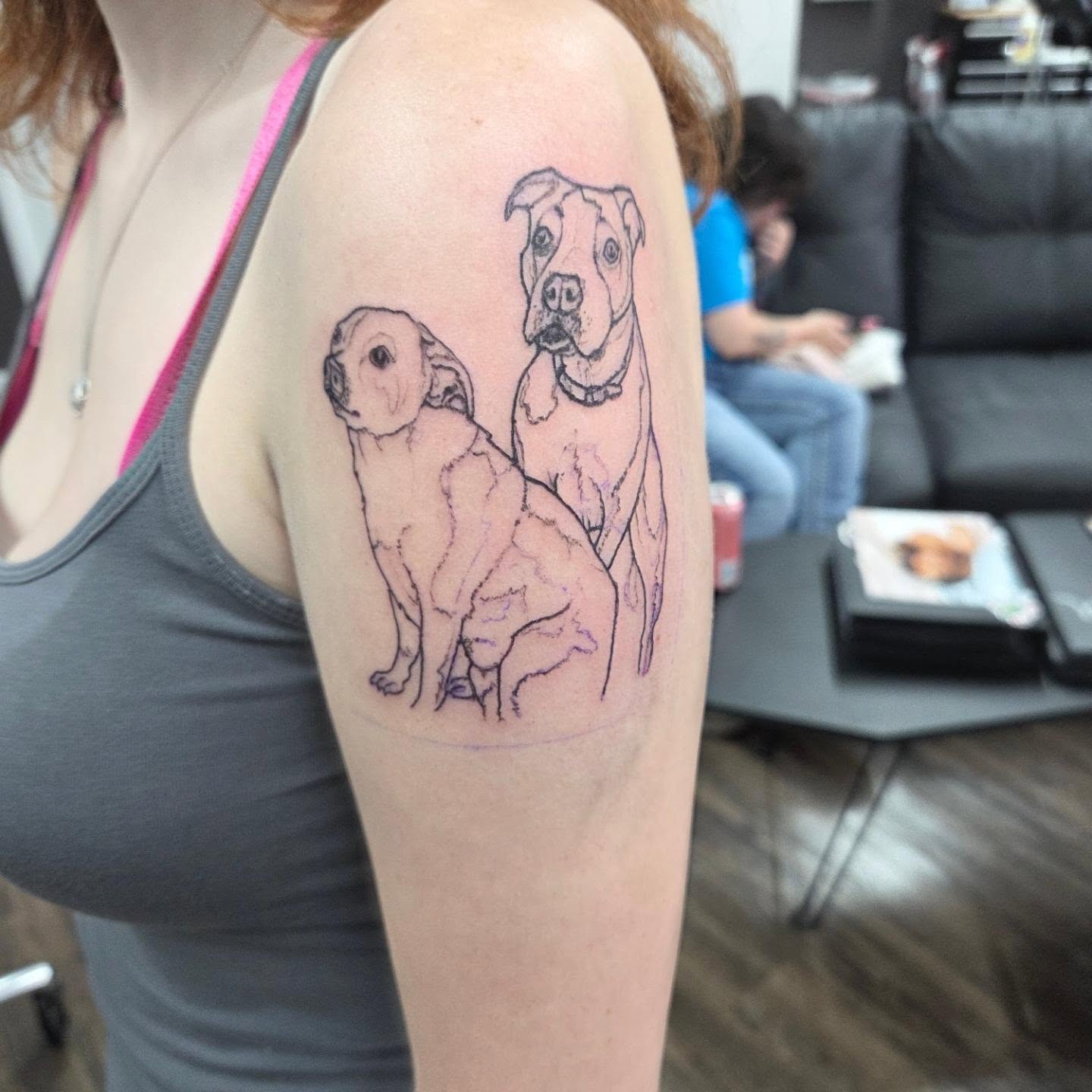 Dogs realism tattoo on the upper arm by Matthew Todd Kremer