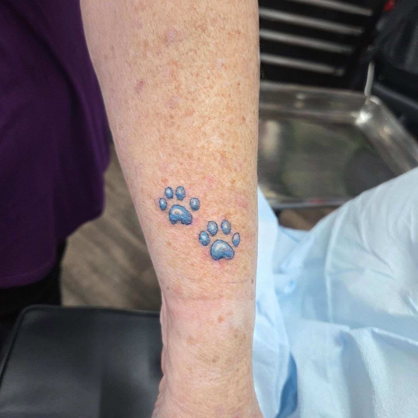 Paw prints dotwork tattoo on the forearm by Matthew Todd Kremer