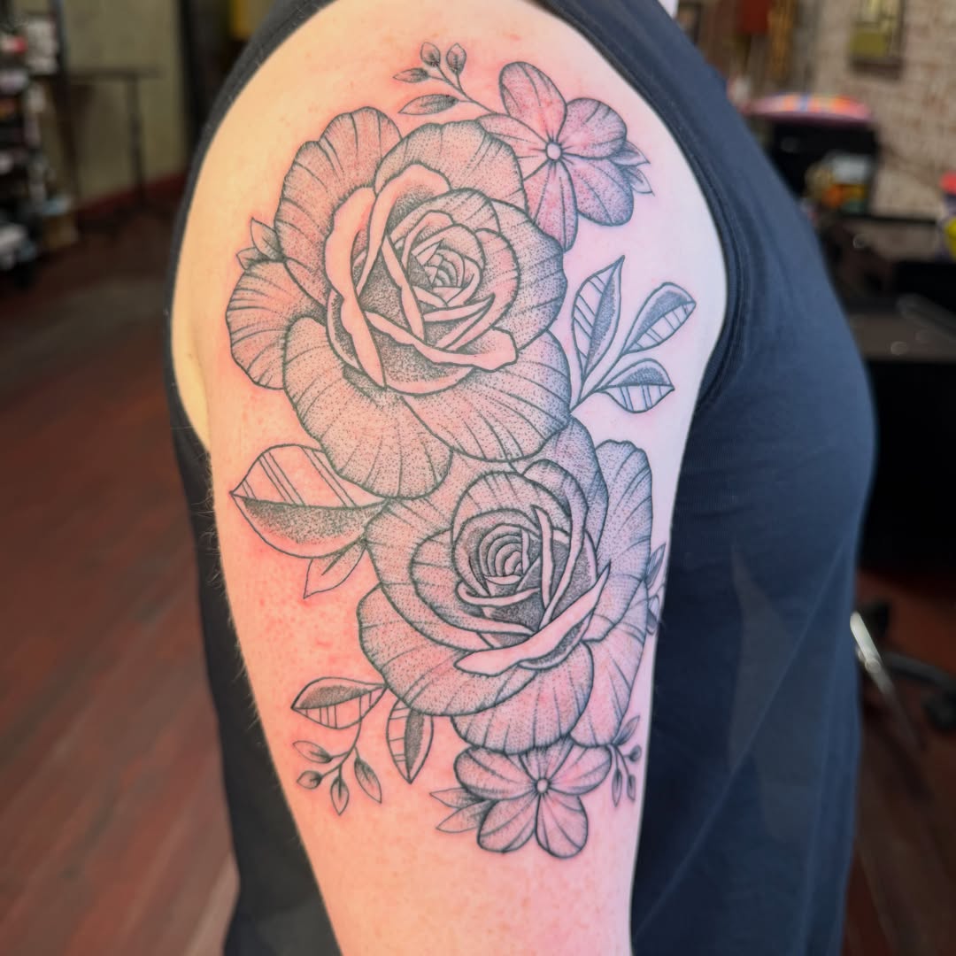 Roses dotwork tattoo on the upper arm by Evan Voelker