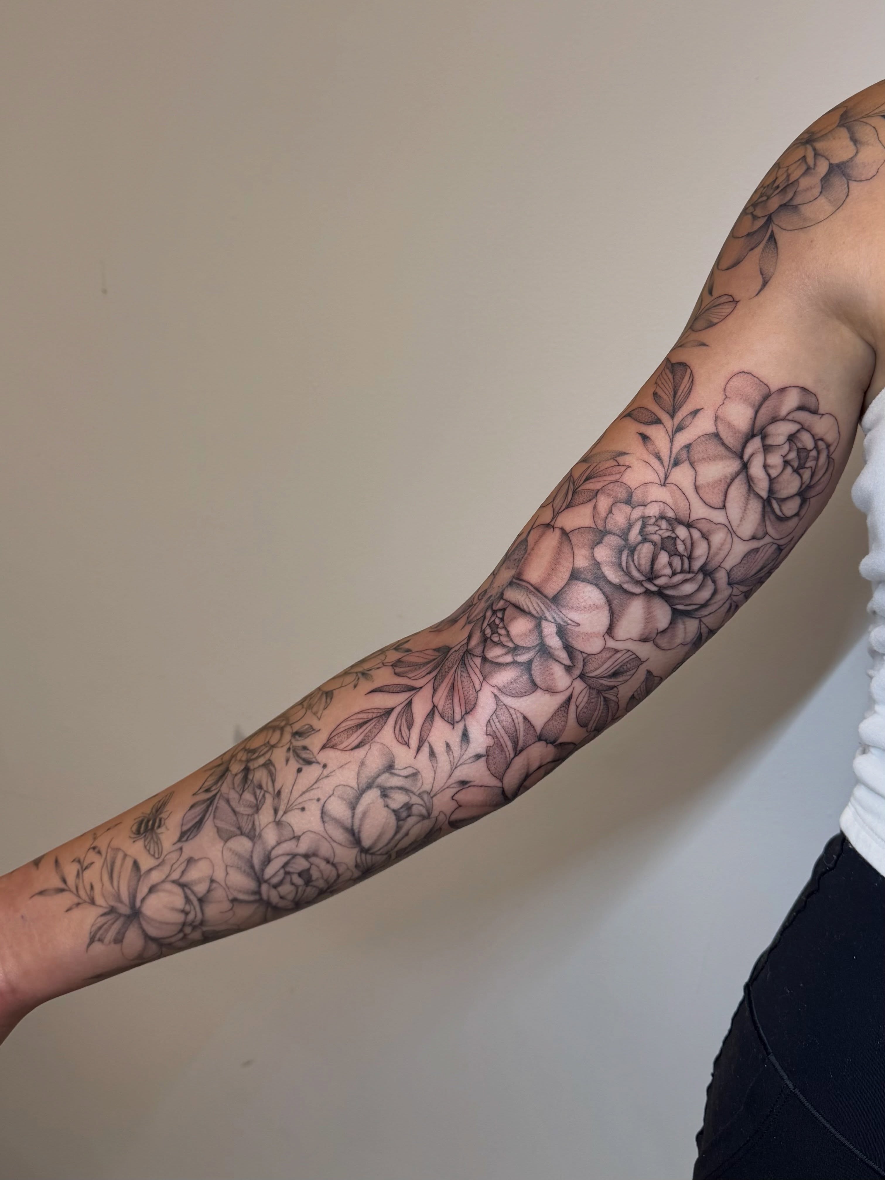 Floral bouquet black and grey tattoo on the forearm by Bridget Smith