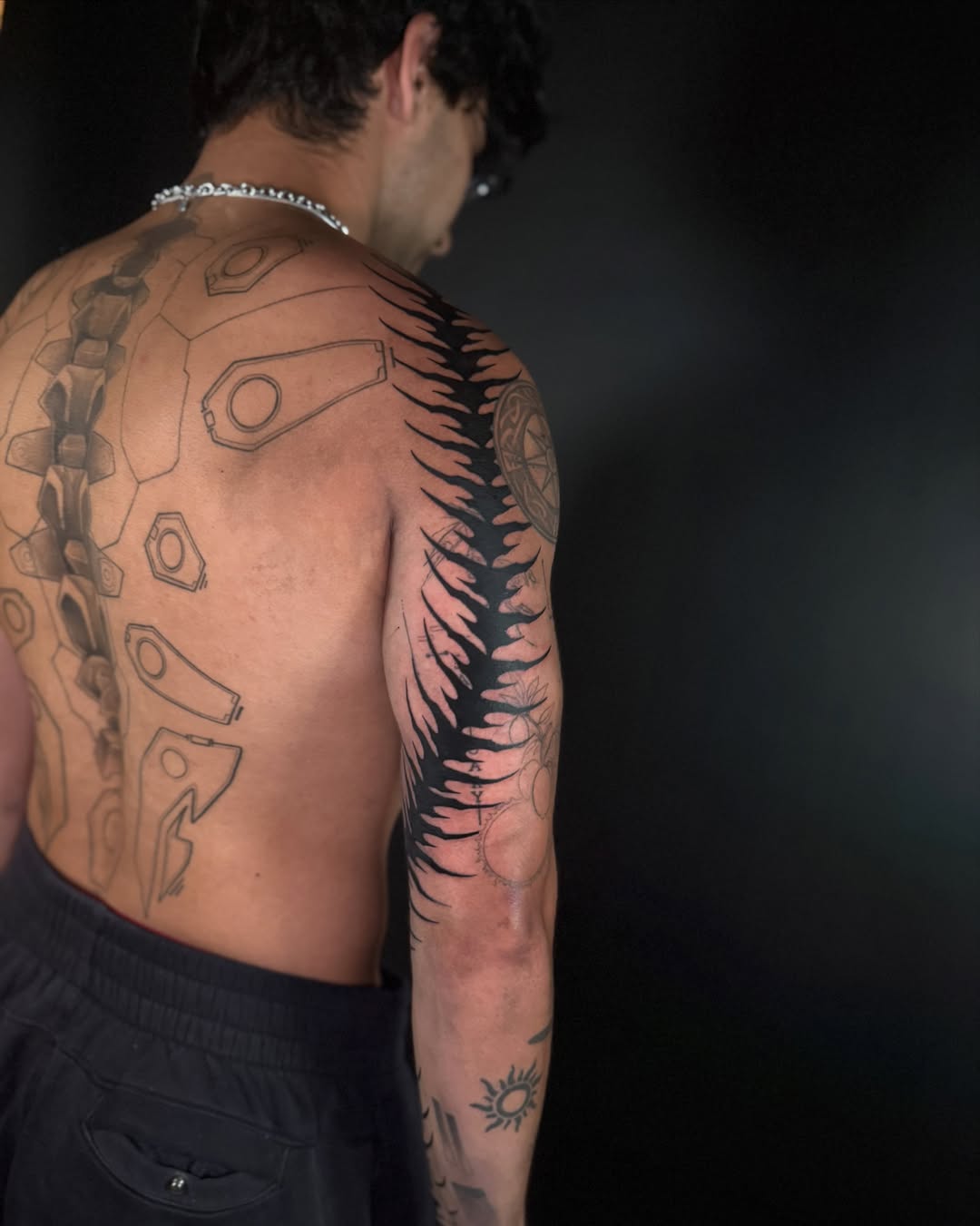 Mechanical armor black and grey tattoo on the back by Dylan Orbock, Berkeley, California