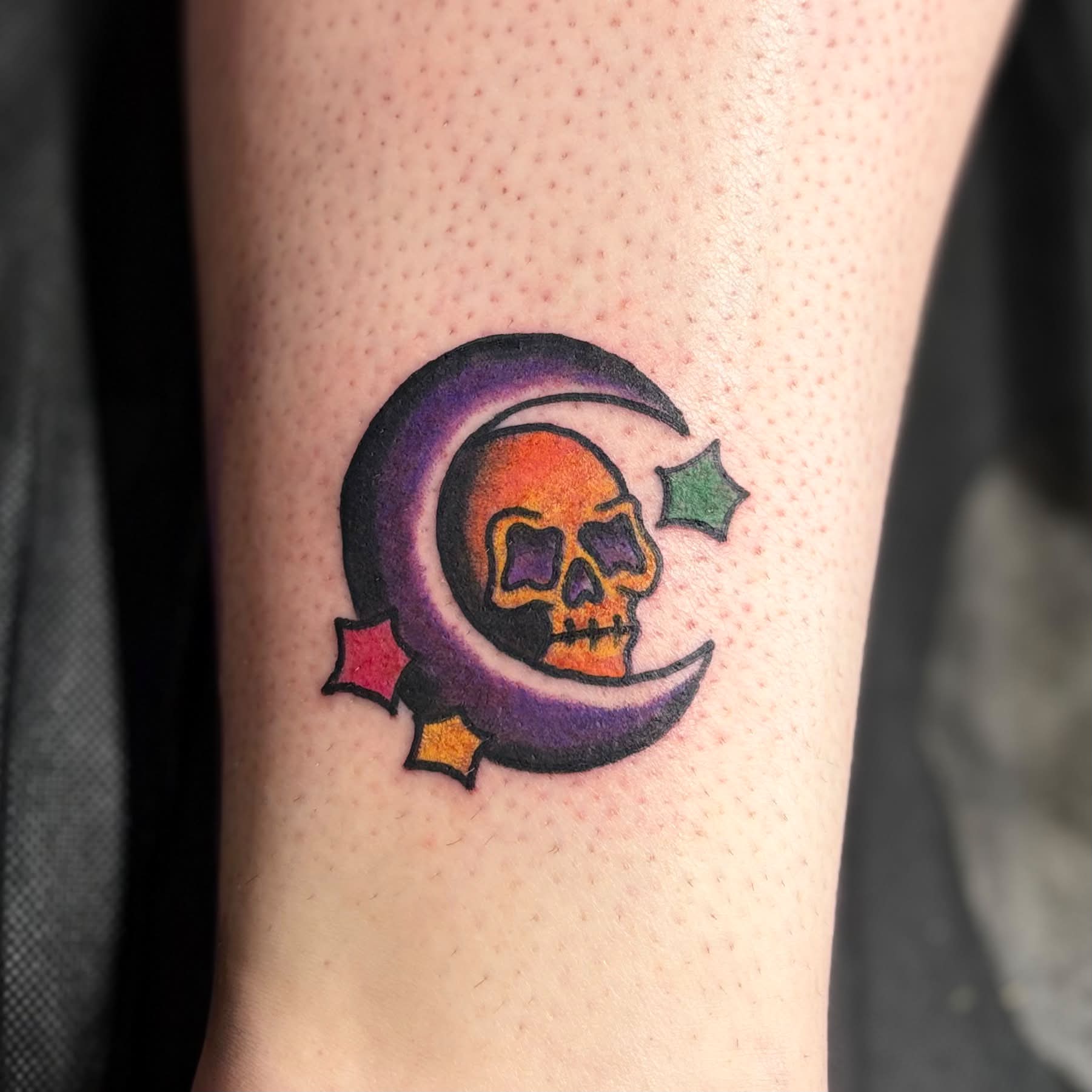 Skull and crescent moon American traditional tattoo on the forearm by Jon Anderson