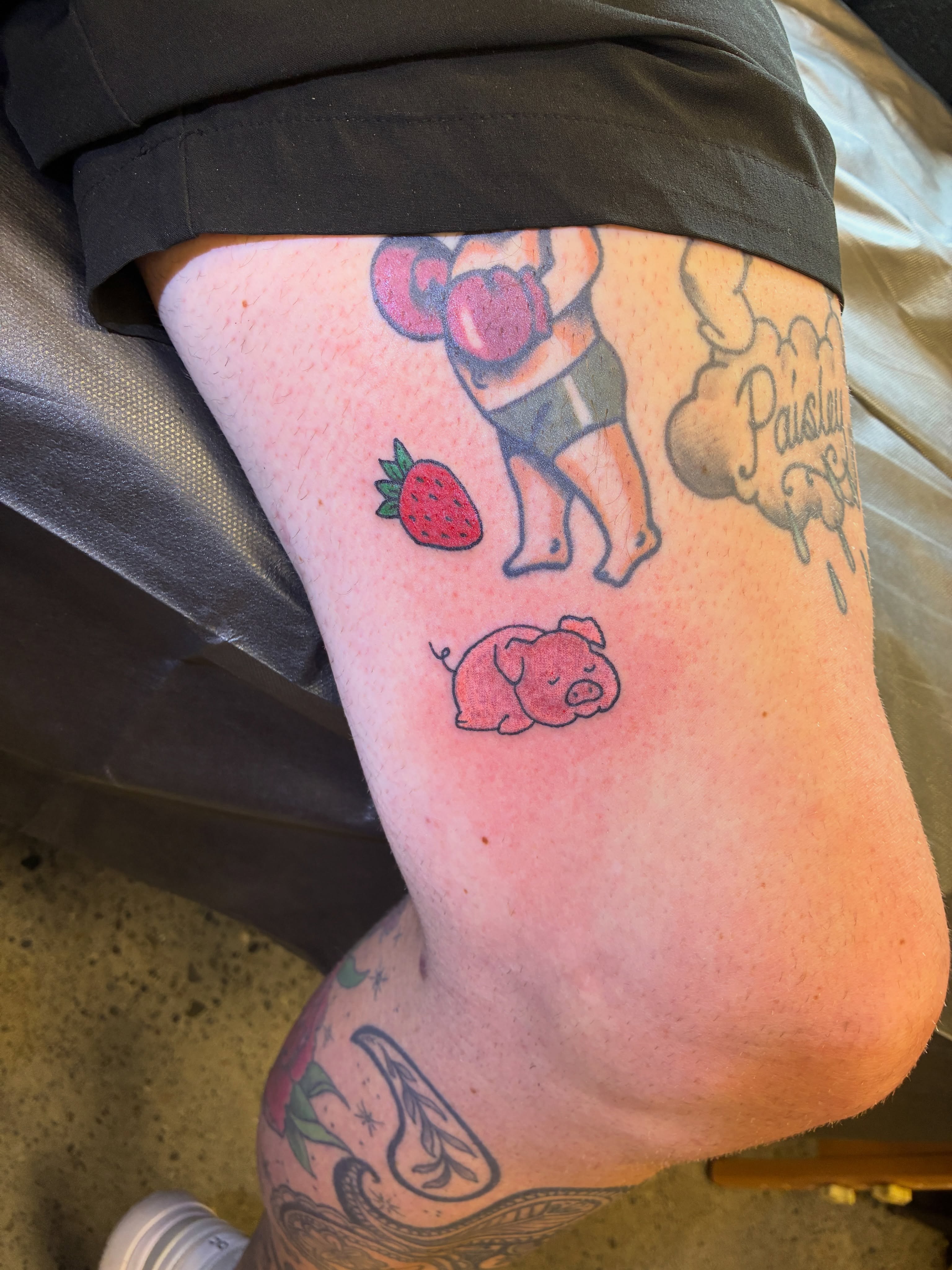 Pig and strawberry American traditional tattoo on the thigh by Seattle Tattoo Artist
