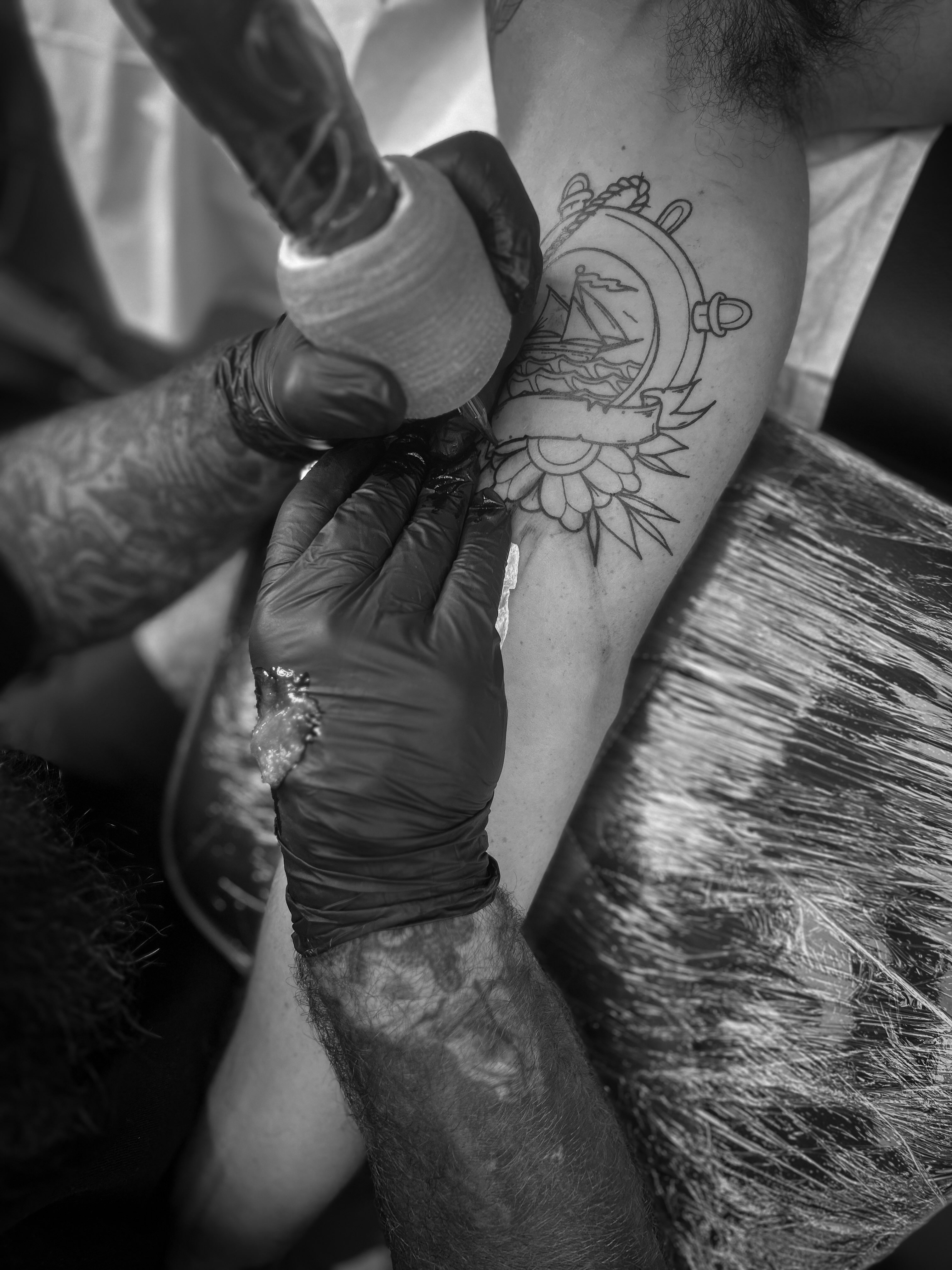 Compass and ship black and grey tattoo on the forearm by Andres Flores