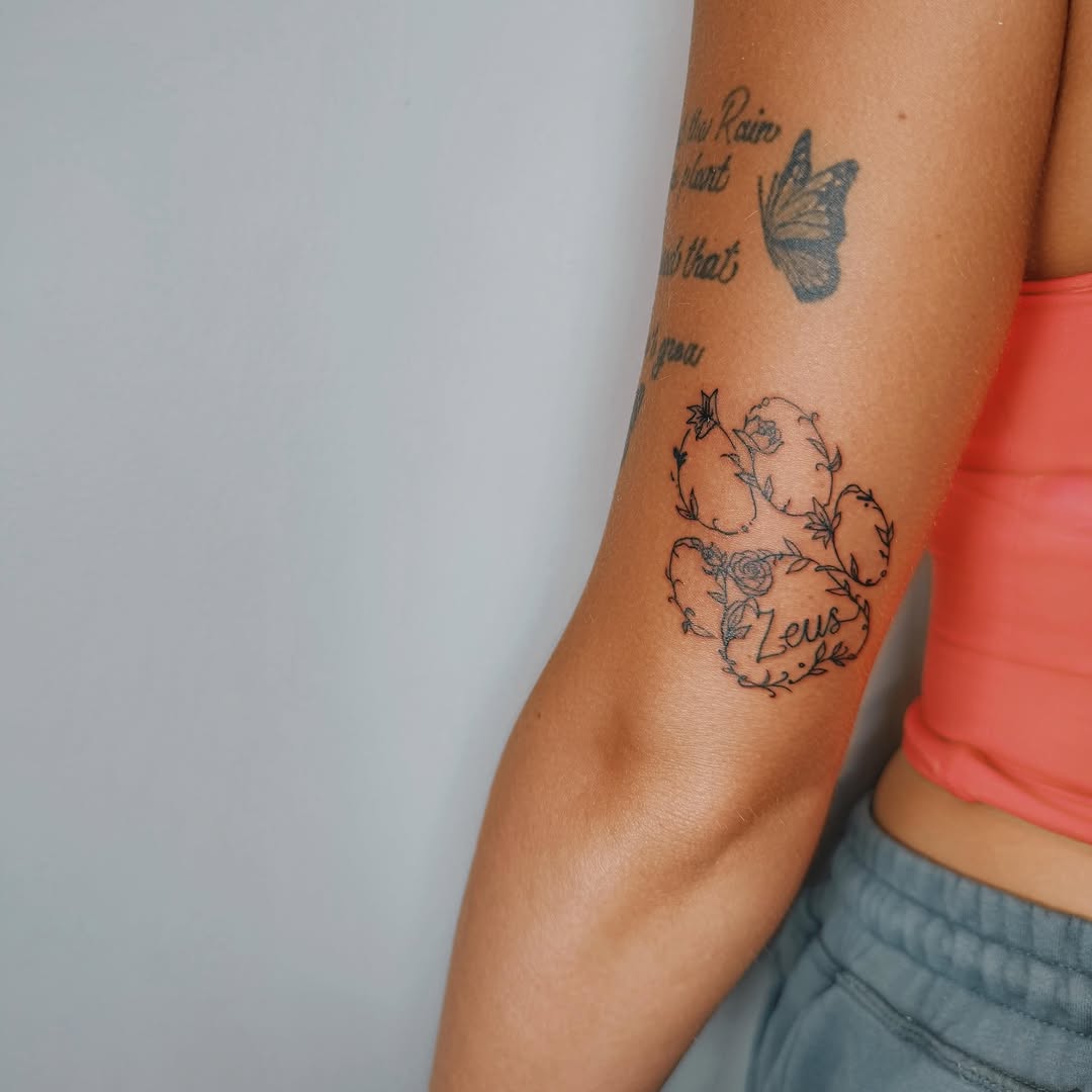 Butterfly and floral wreath black and grey tattoo on the forearm by Ashlee Burkey