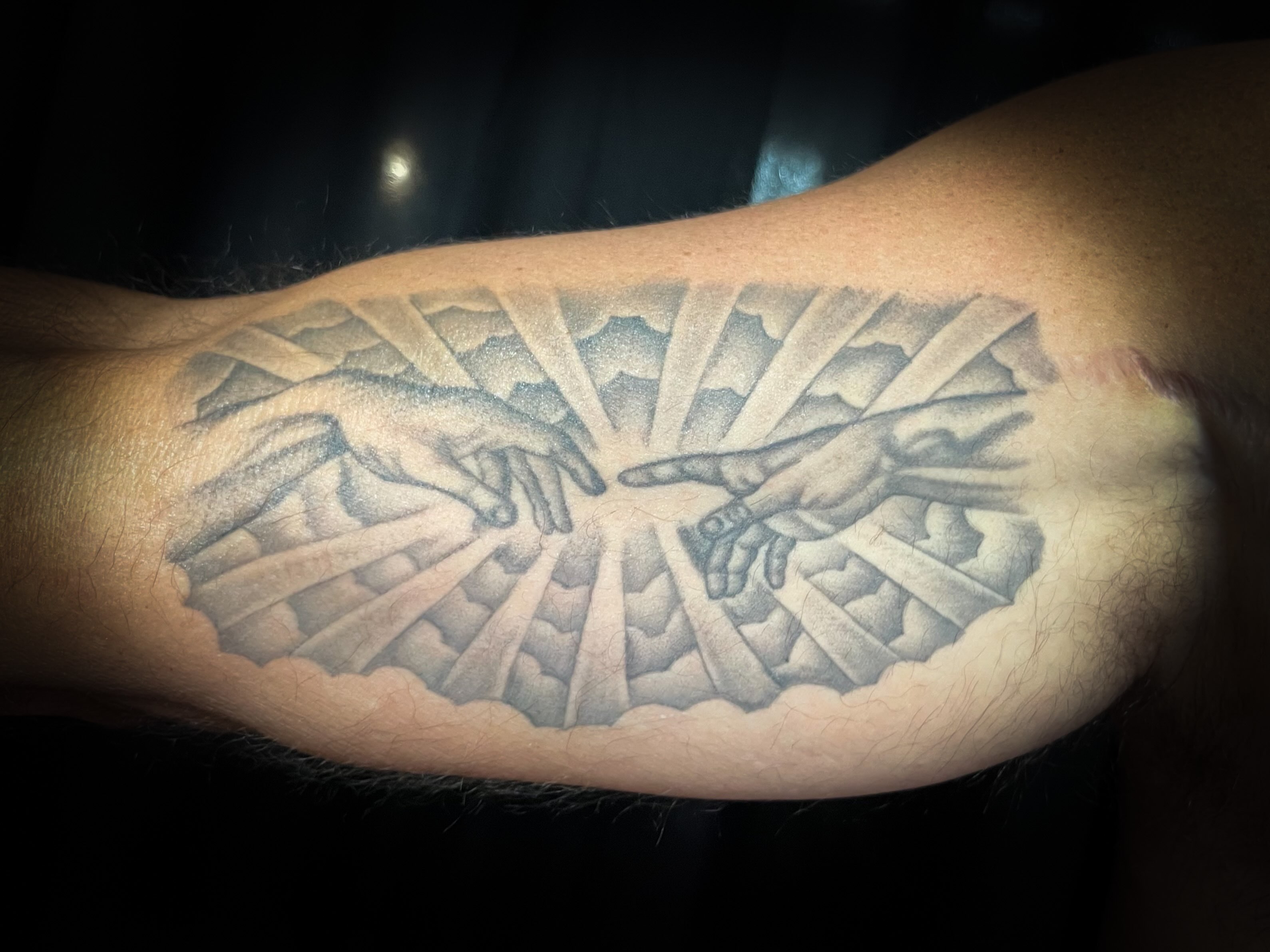 Creation scene geometric tattoo on the forearm by Melissa Peña NYC