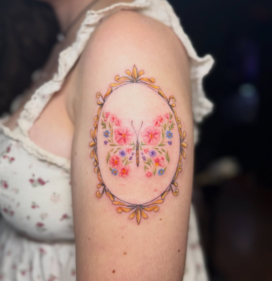 Butterfly and floral wreath watercolor tattoo on the forearm by Bri ⚡️✨