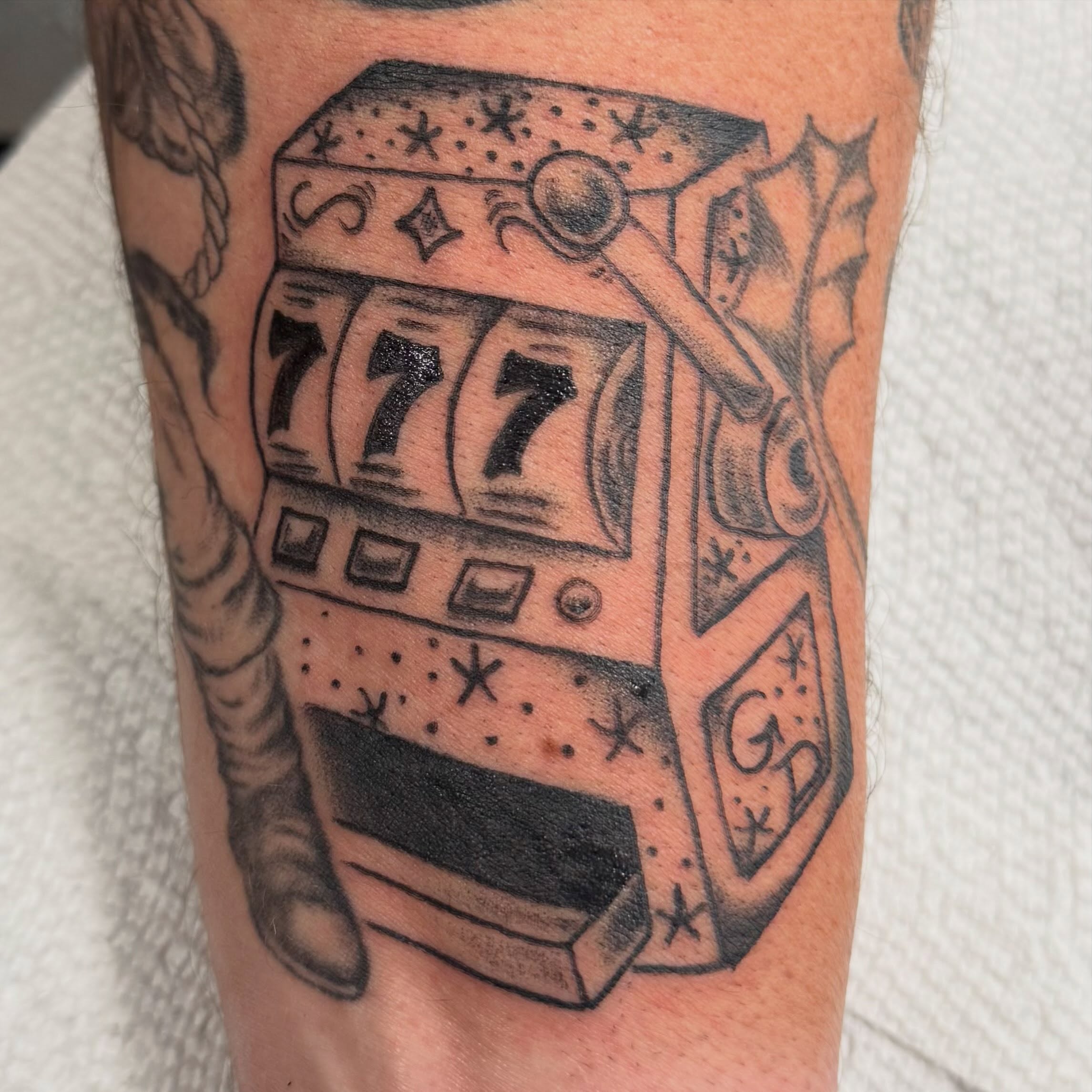 Slot machine American traditional tattoo on the forearm by Elmer Lethco