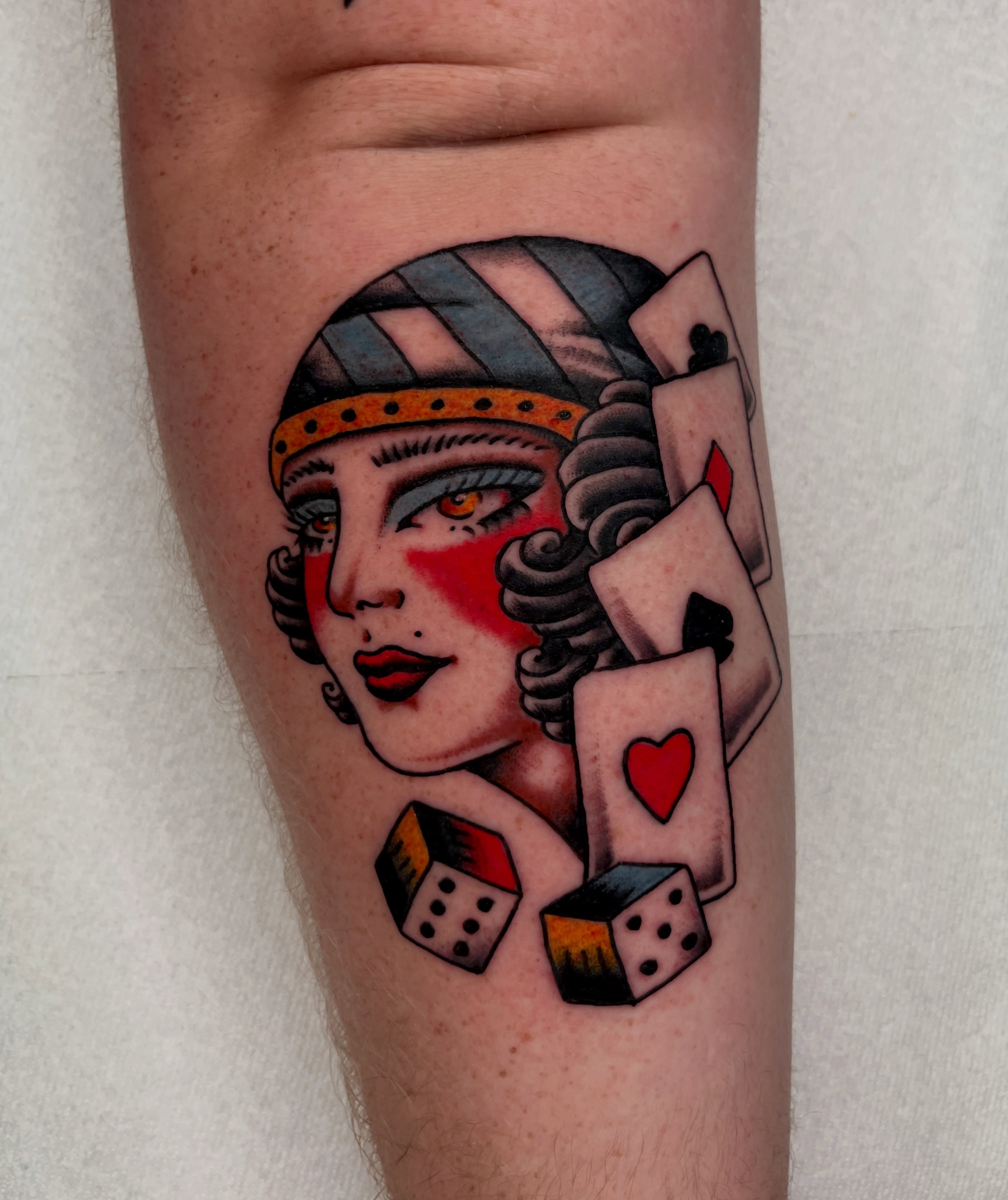 Woman with playing cards American traditional tattoo on the forearm by Kehrmie Tattoos, Berkeley, California