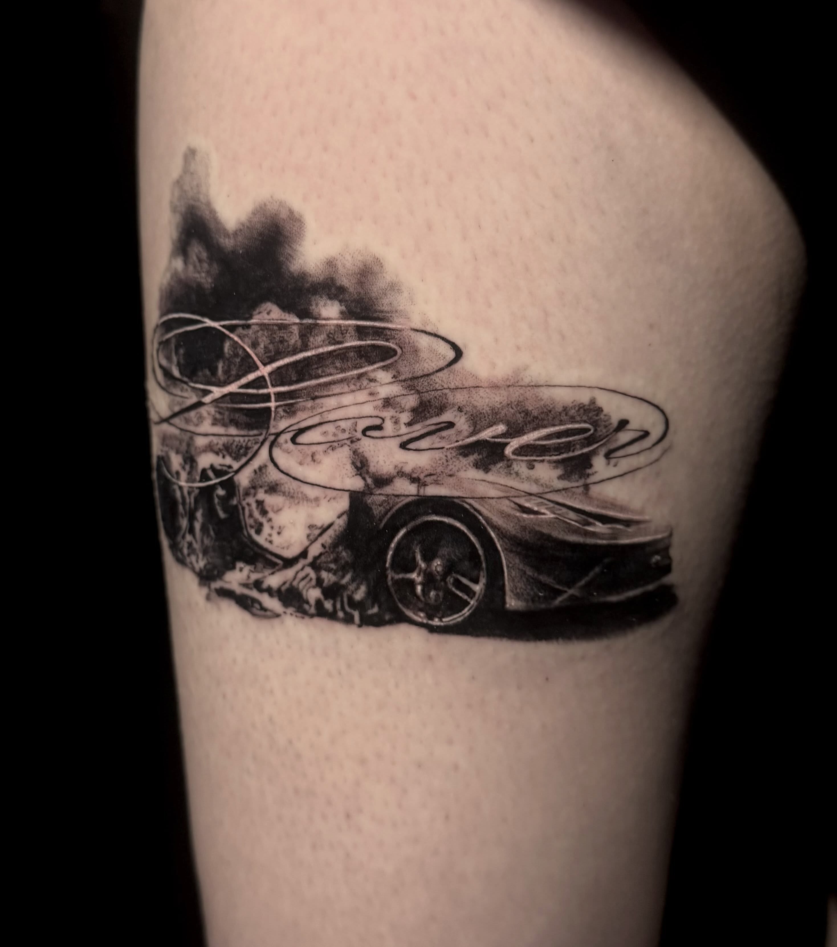 Race car realism tattoo on the thigh by Claire Litsey