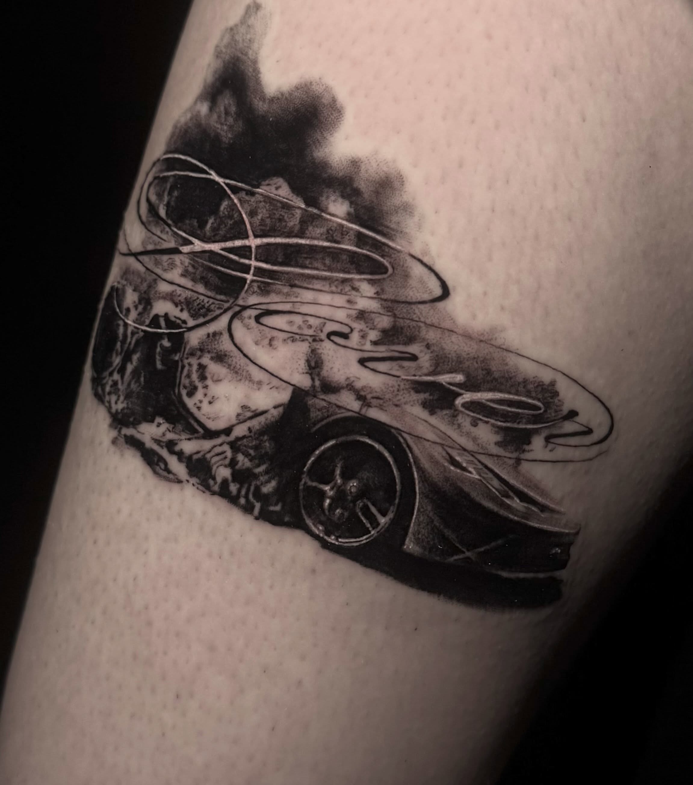 Burning car realism tattoo on the forearm by Claire Litsey