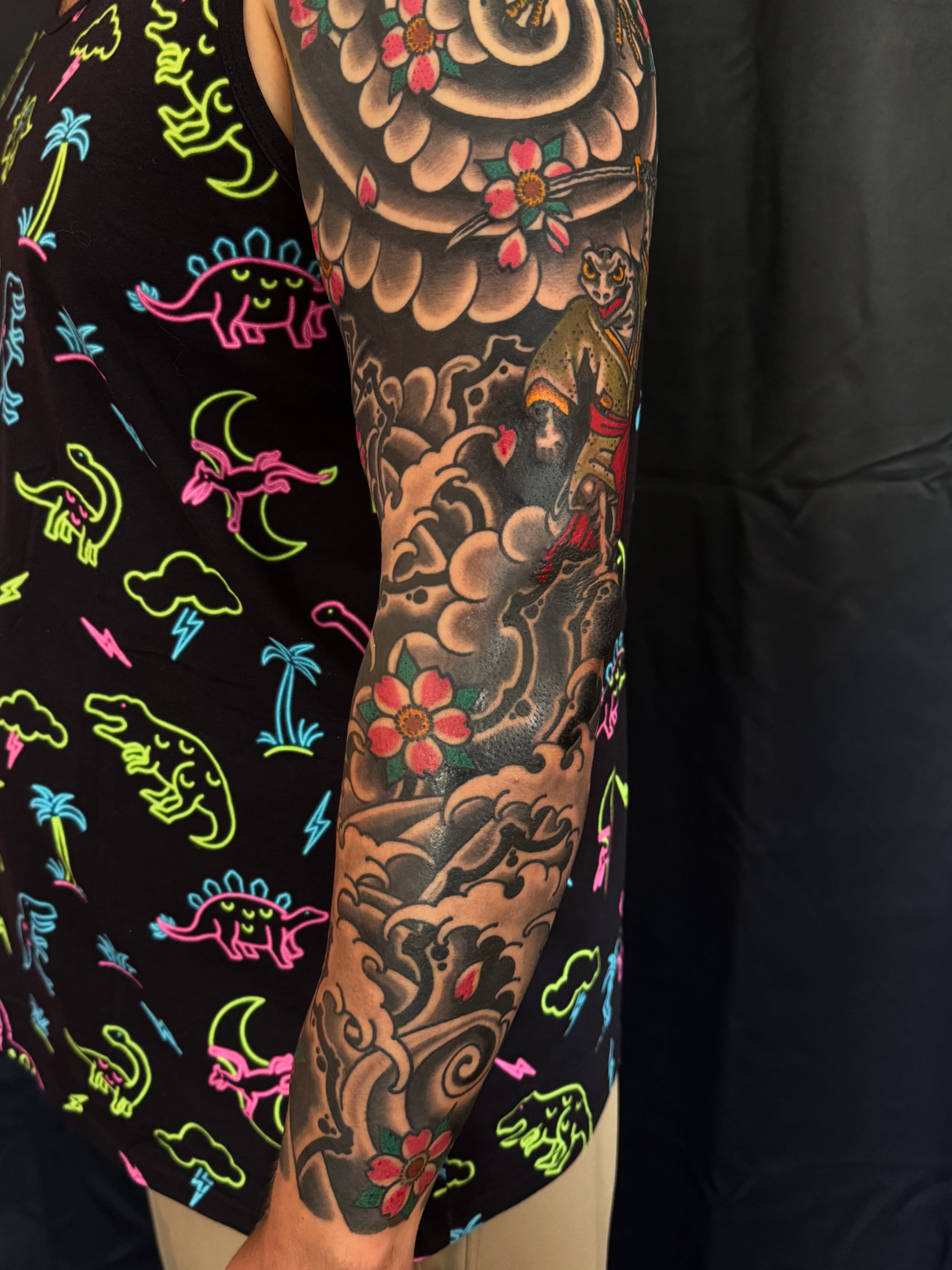 Wave and flower American traditional tattoo on the forearm by Nicholas Tidler