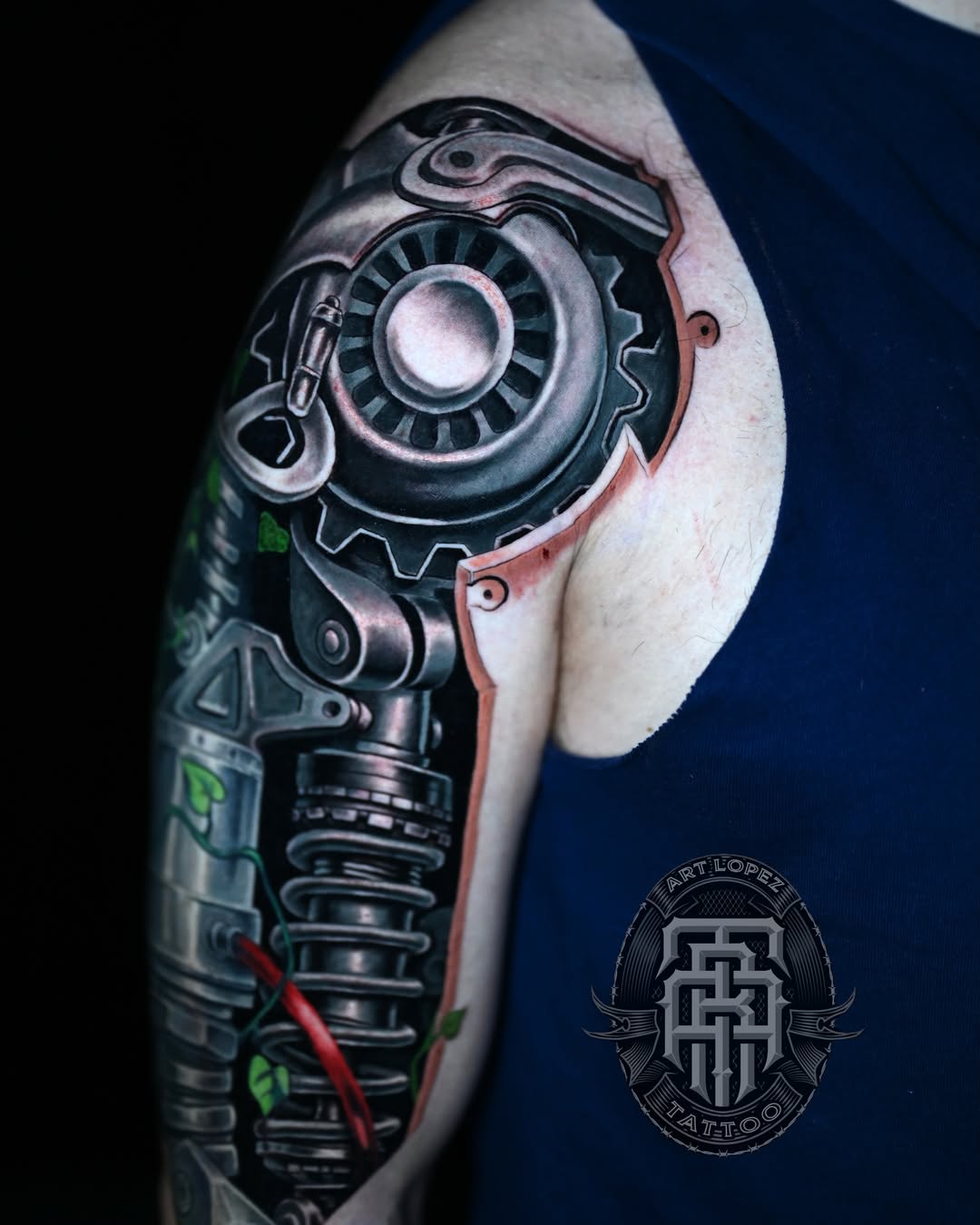 Mechanical gear realism tattoo on the upper arm by Art Lopez