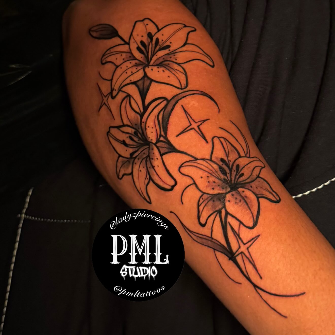 Lilies black and grey tattoo on the forearm by PMLSTUDIO ✡️ Atlanta Licensed Artist, Decatur, Georgia