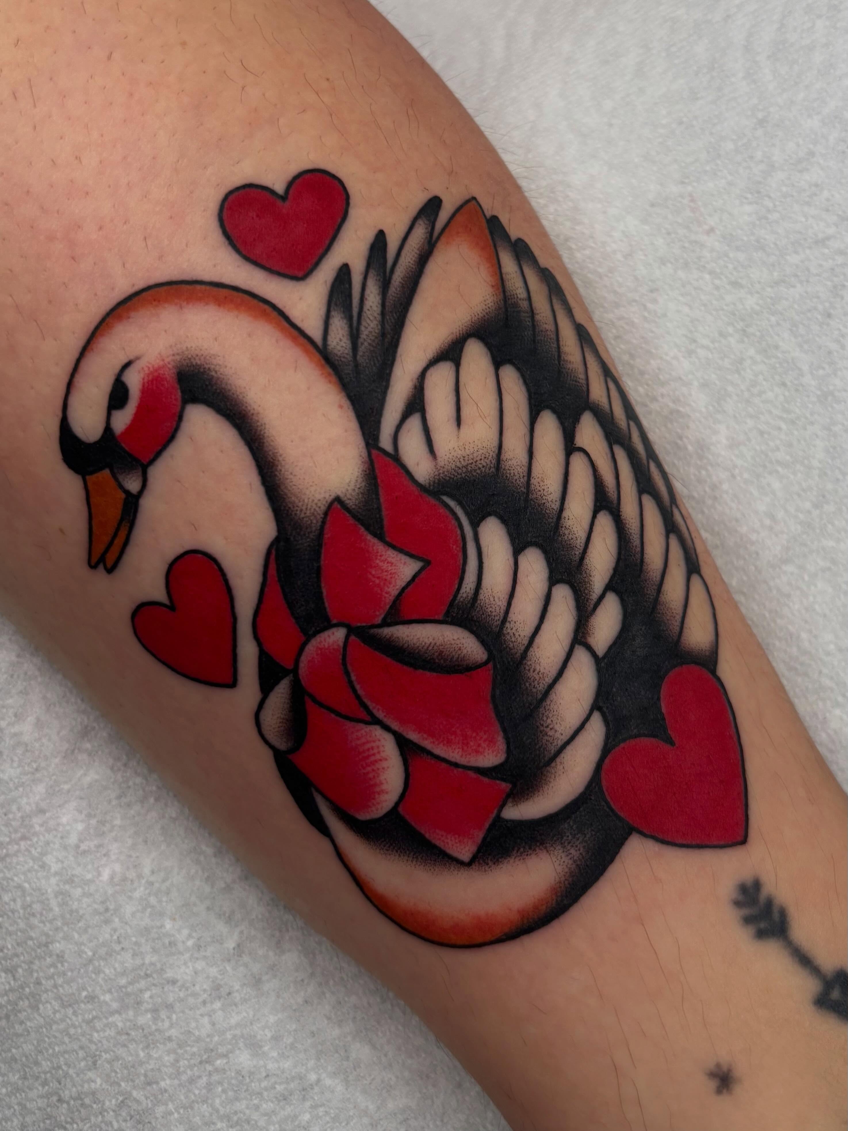Swan with hearts American traditional tattoo on the forearm by Claire Anderson