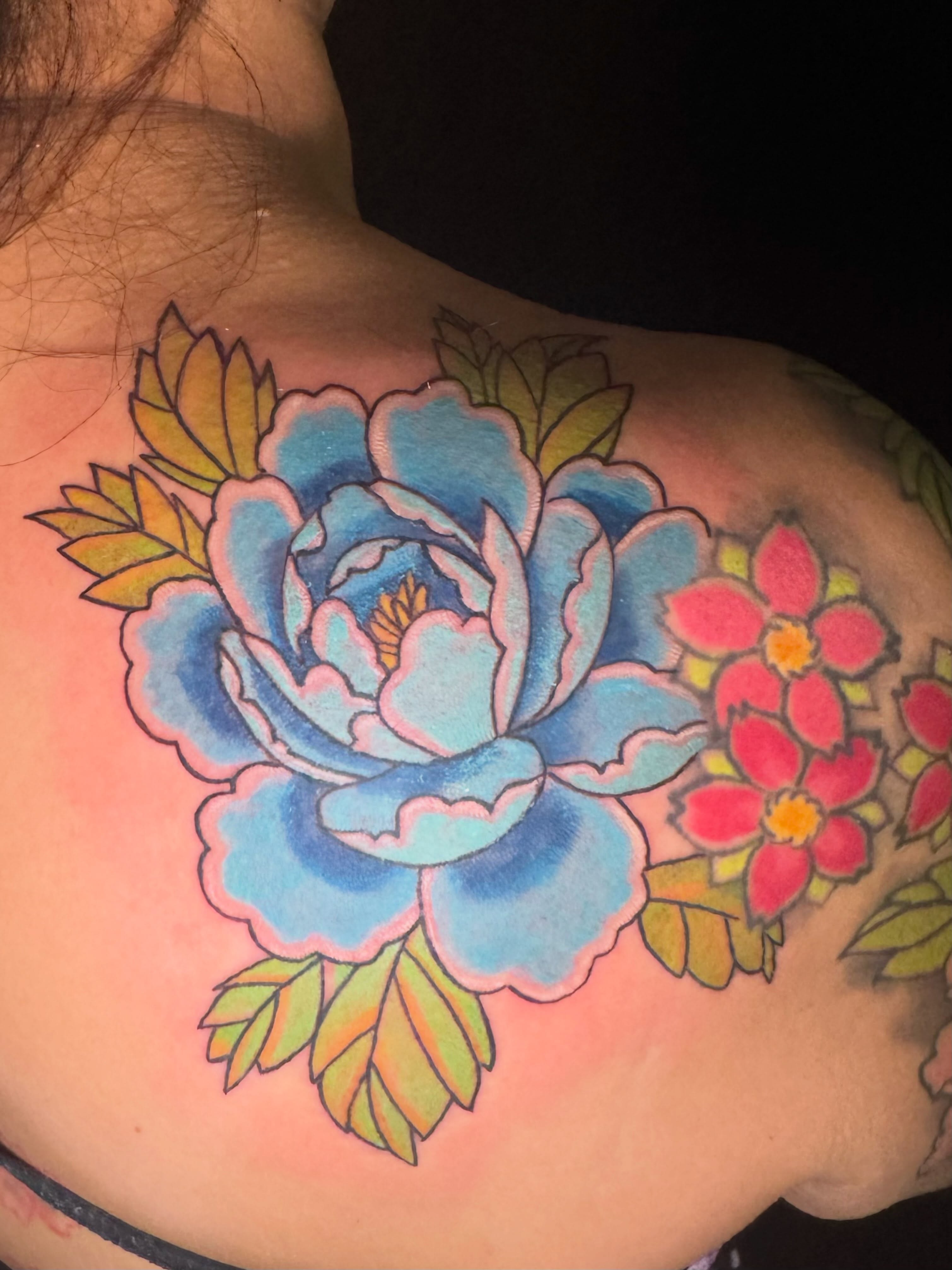 Blue rose American traditional tattoo on the shoulder by Erik Pagtakhan