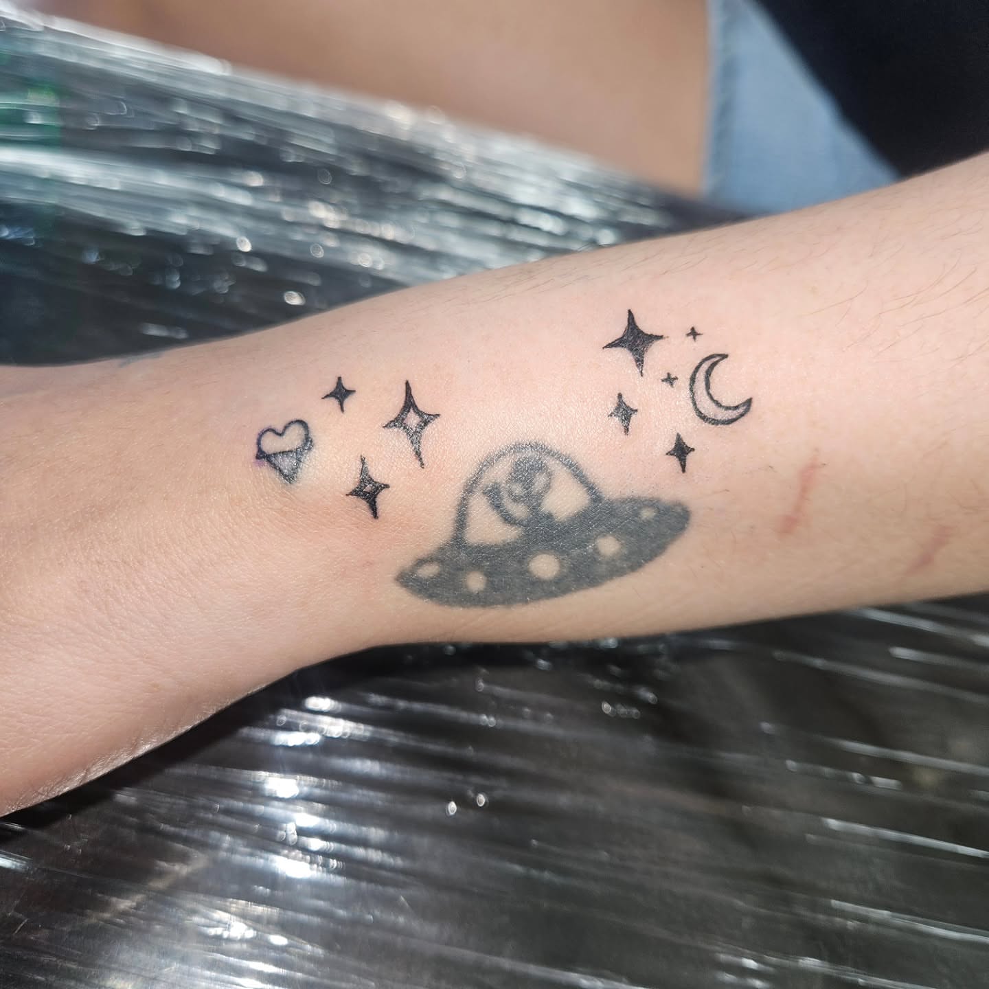 Space-themed dotwork tattoo on the forearm by Mischief π€