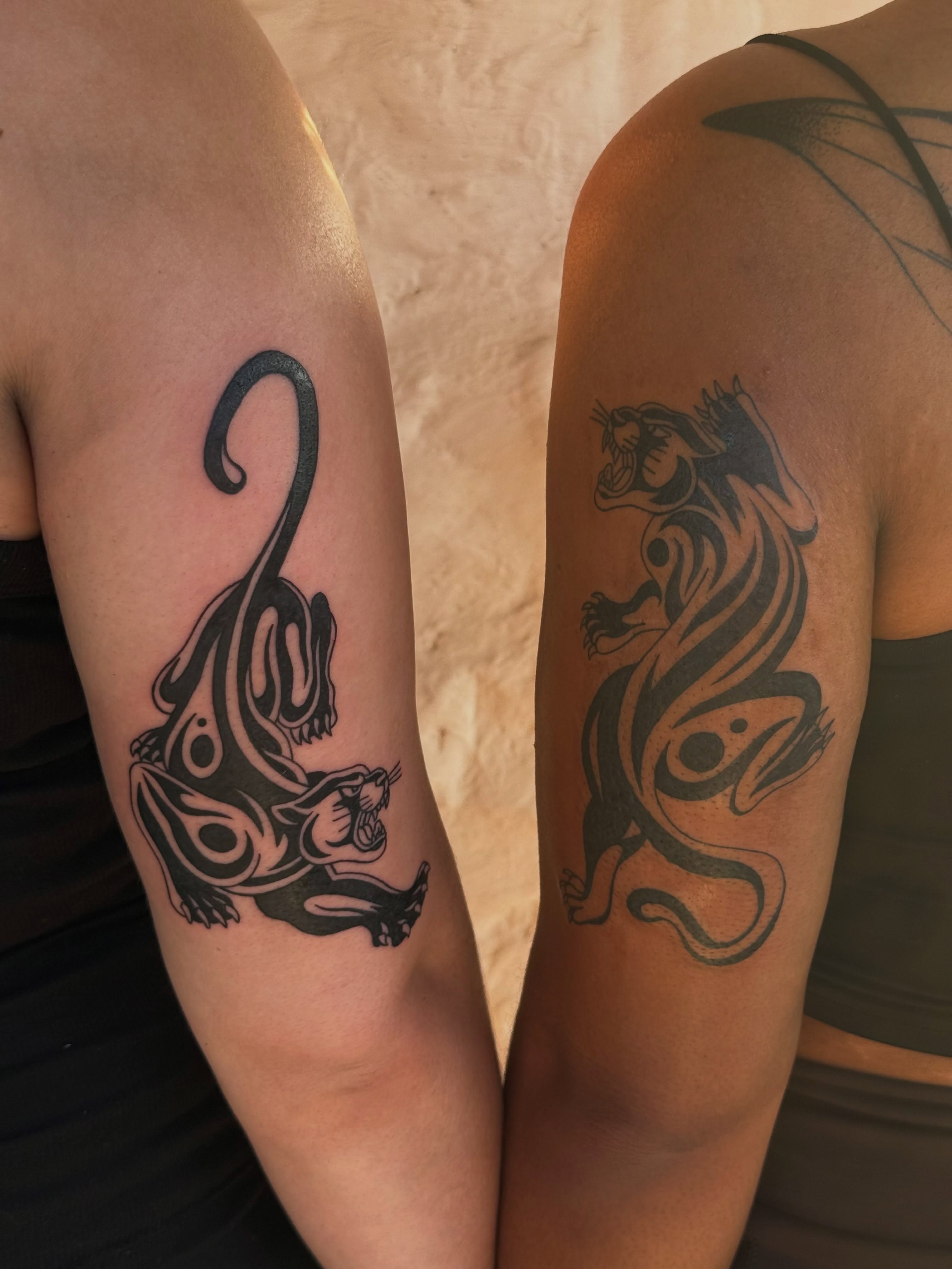 Panther tribal tattoo on the upper arm by sarah