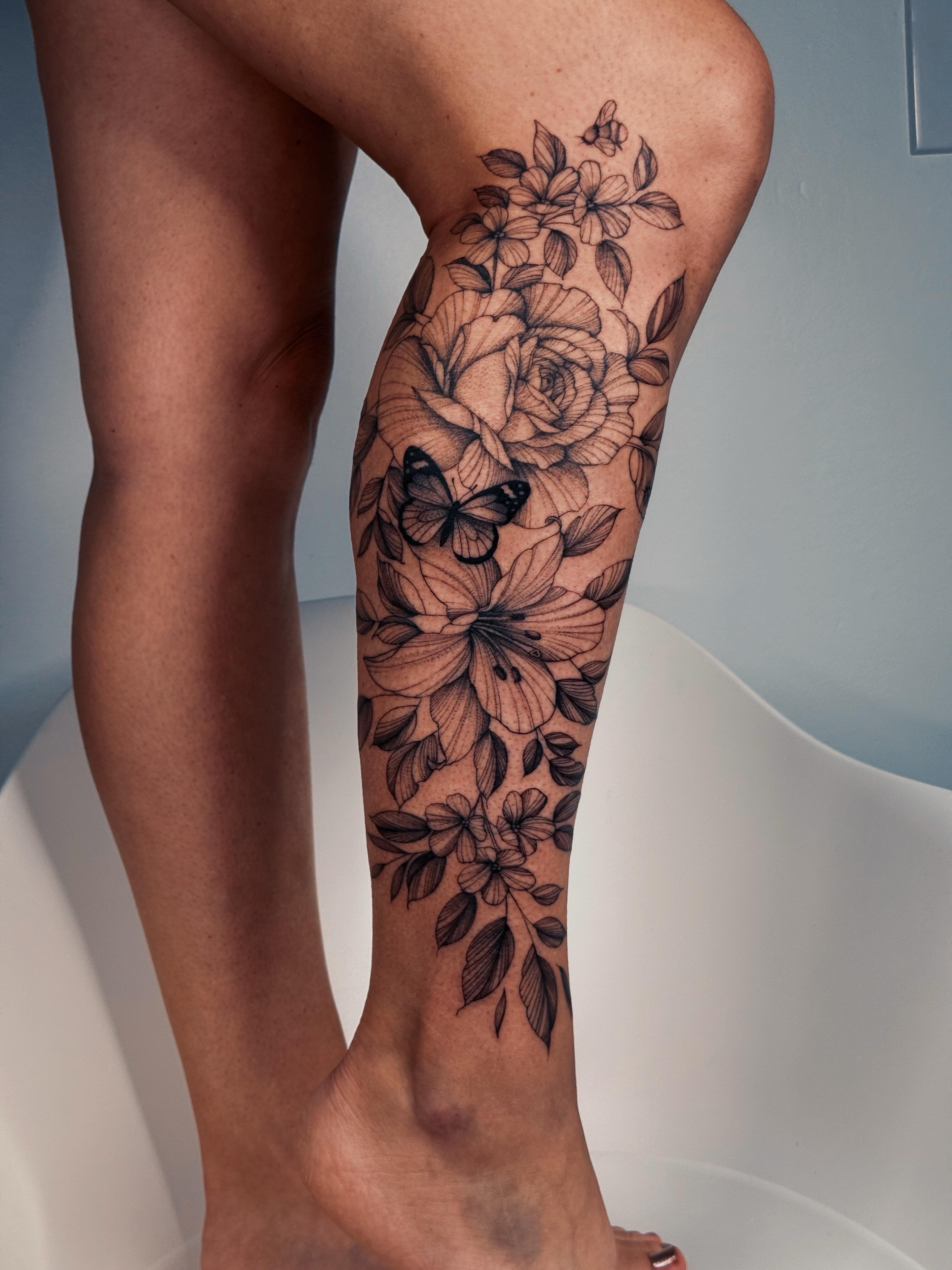 Floral bouquet realism tattoo on the calf by Olha Tytarenko