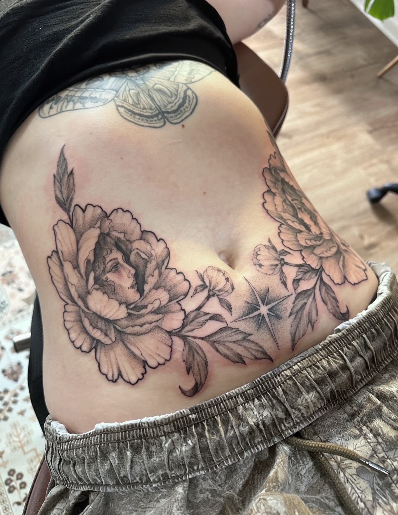 Peony flower black and grey tattoo on the ribs by Allexis