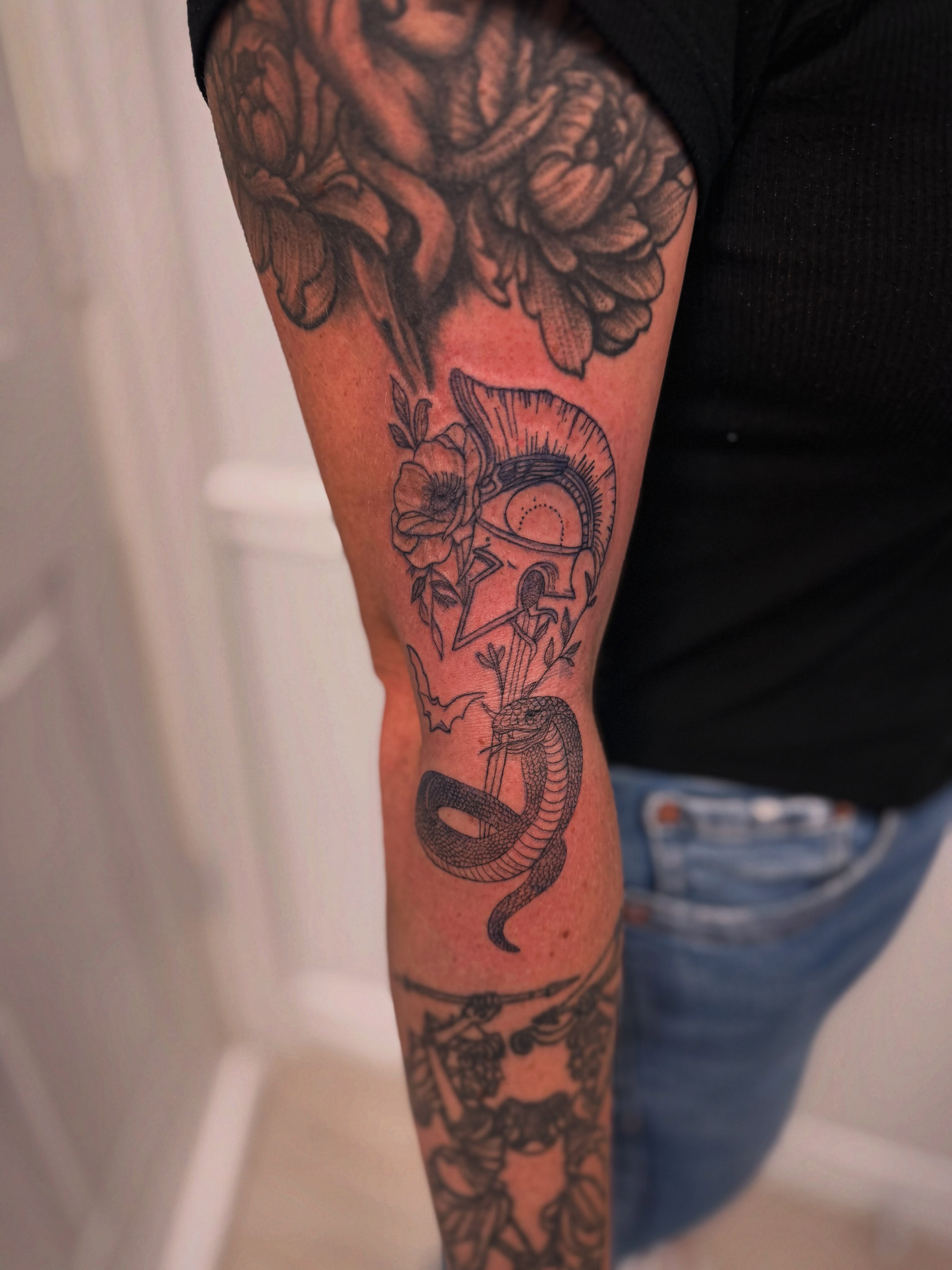 Snake and helmet realism tattoo on the forearm by Taylor Johnson