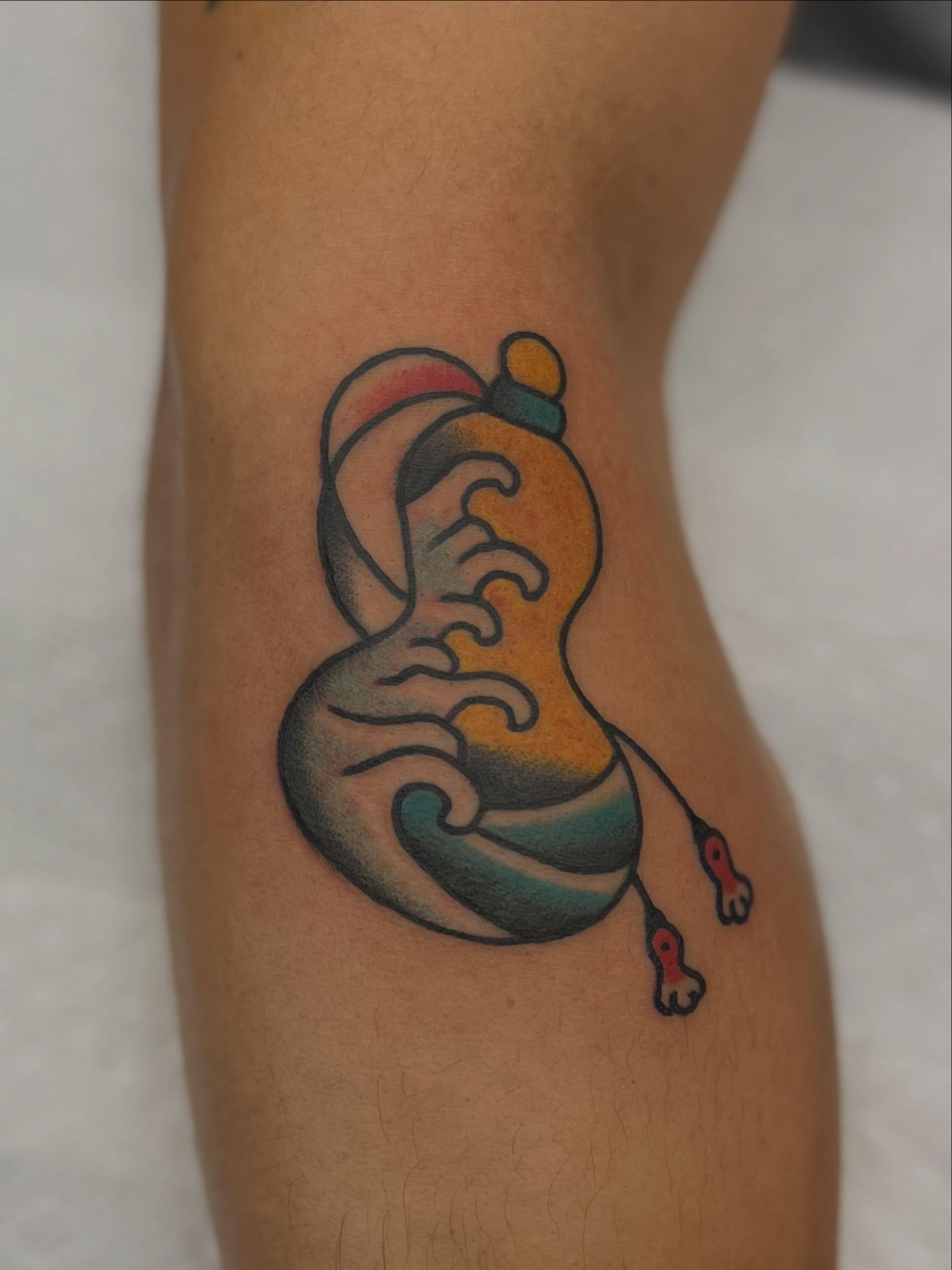 Wave and feet American traditional tattoo on the leg by Mikey Montoya