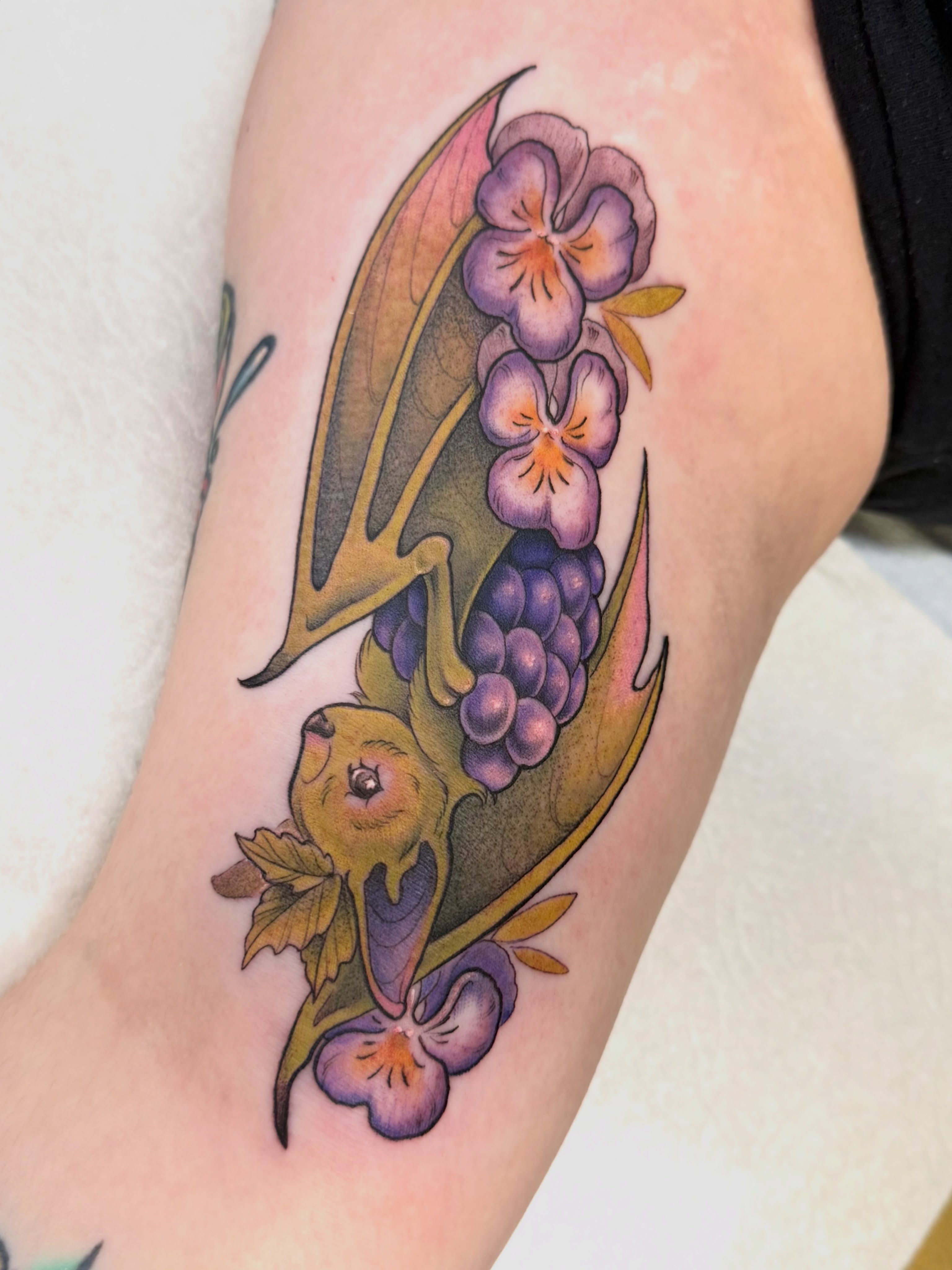 Violet flowers and bat American traditional tattoo on the forearm by Maia Papaya Tattoos 🐝 Olympia Tattoo Artist
