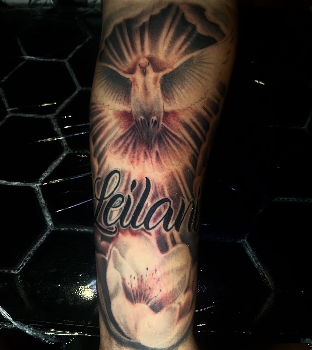 Bird and flower realism tattoo on the forearm by Monstro Ink Arts Tattoos, Bakersfield, California