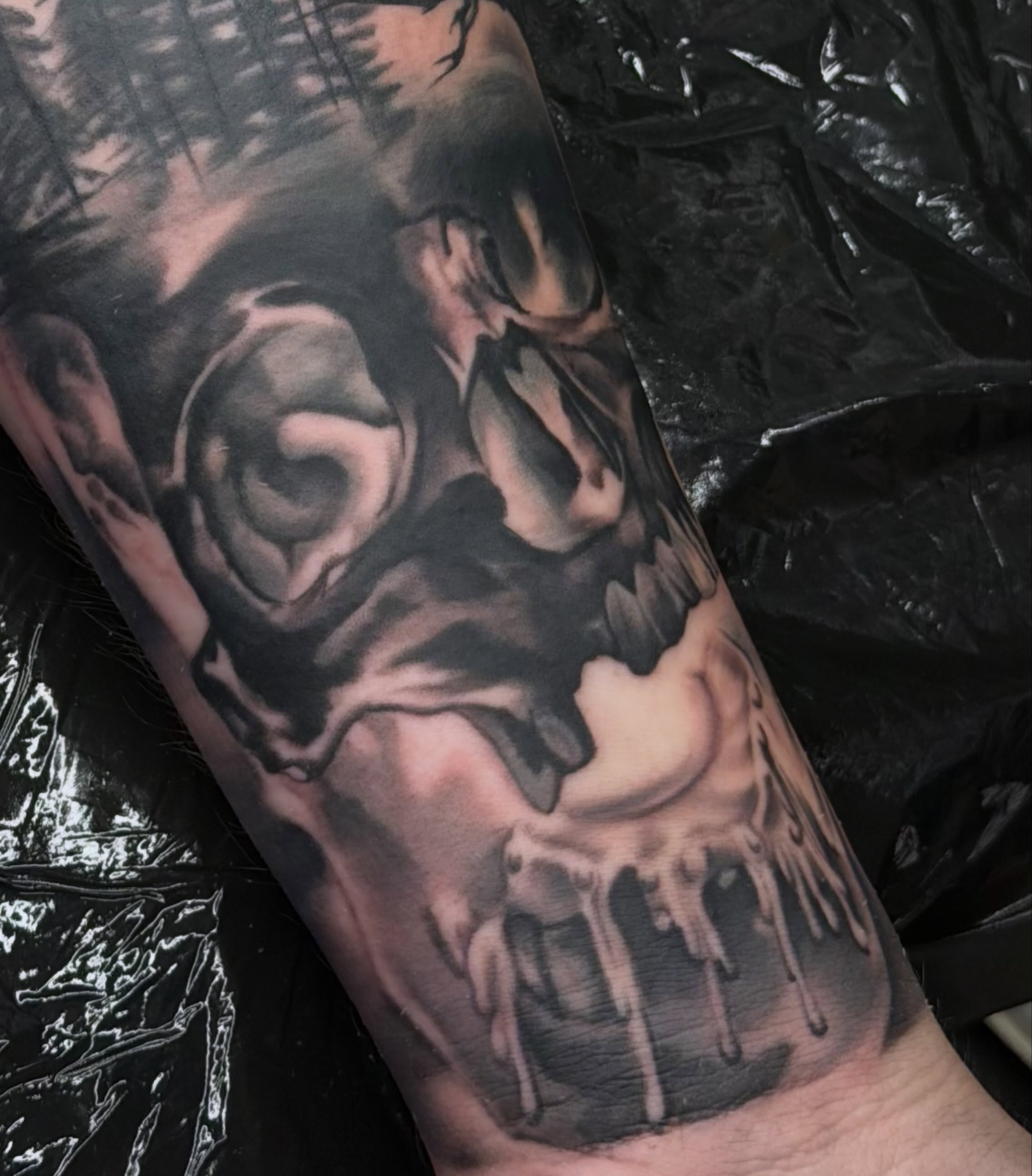 Melting skull dark realism tattoo on the forearm by Lu Ve, Dayton, Ohio