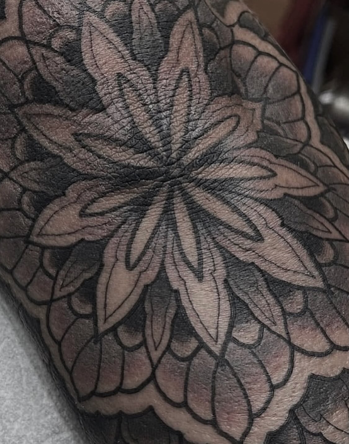 Lotus flower black and grey tattoo on the forearm by Tyler Harrington