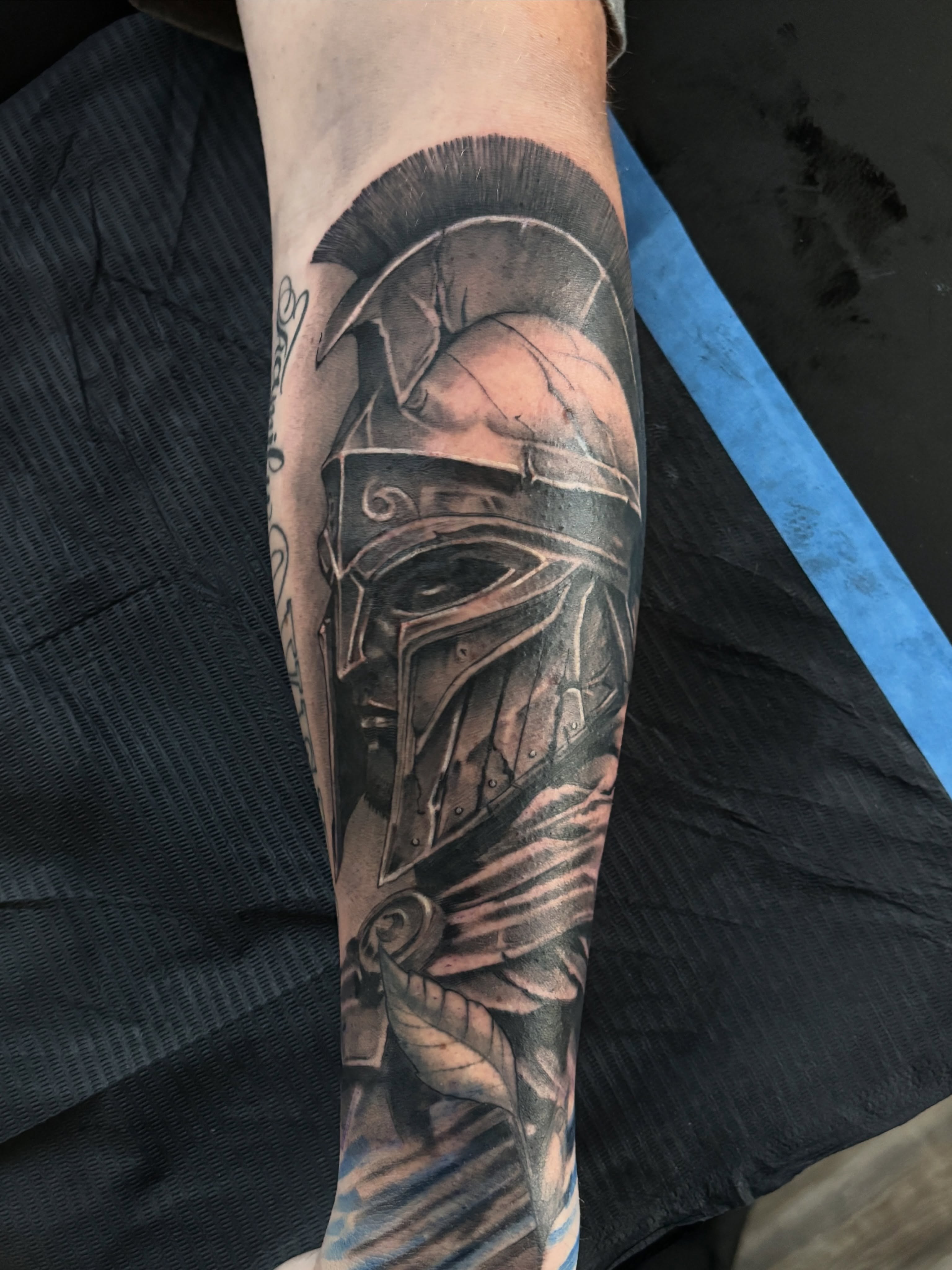 Spartan helmet realism tattoo on the forearm by Luis Marrufo