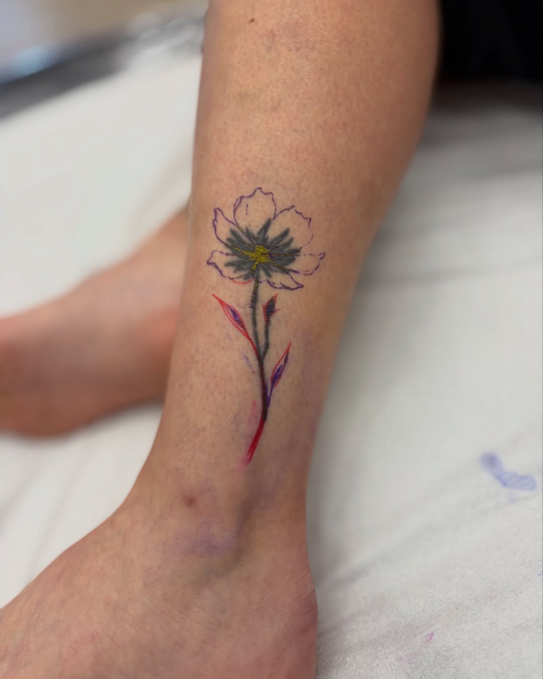 Flower watercolor tattoo on the calf by Ruth Ormsby-Ashworth