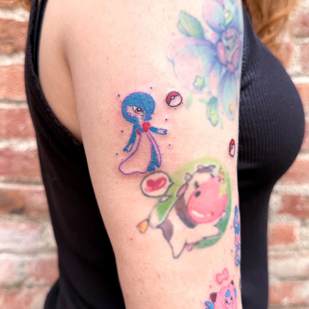 Anime character with cow watercolor tattoo on the forearm by Yez tattoo